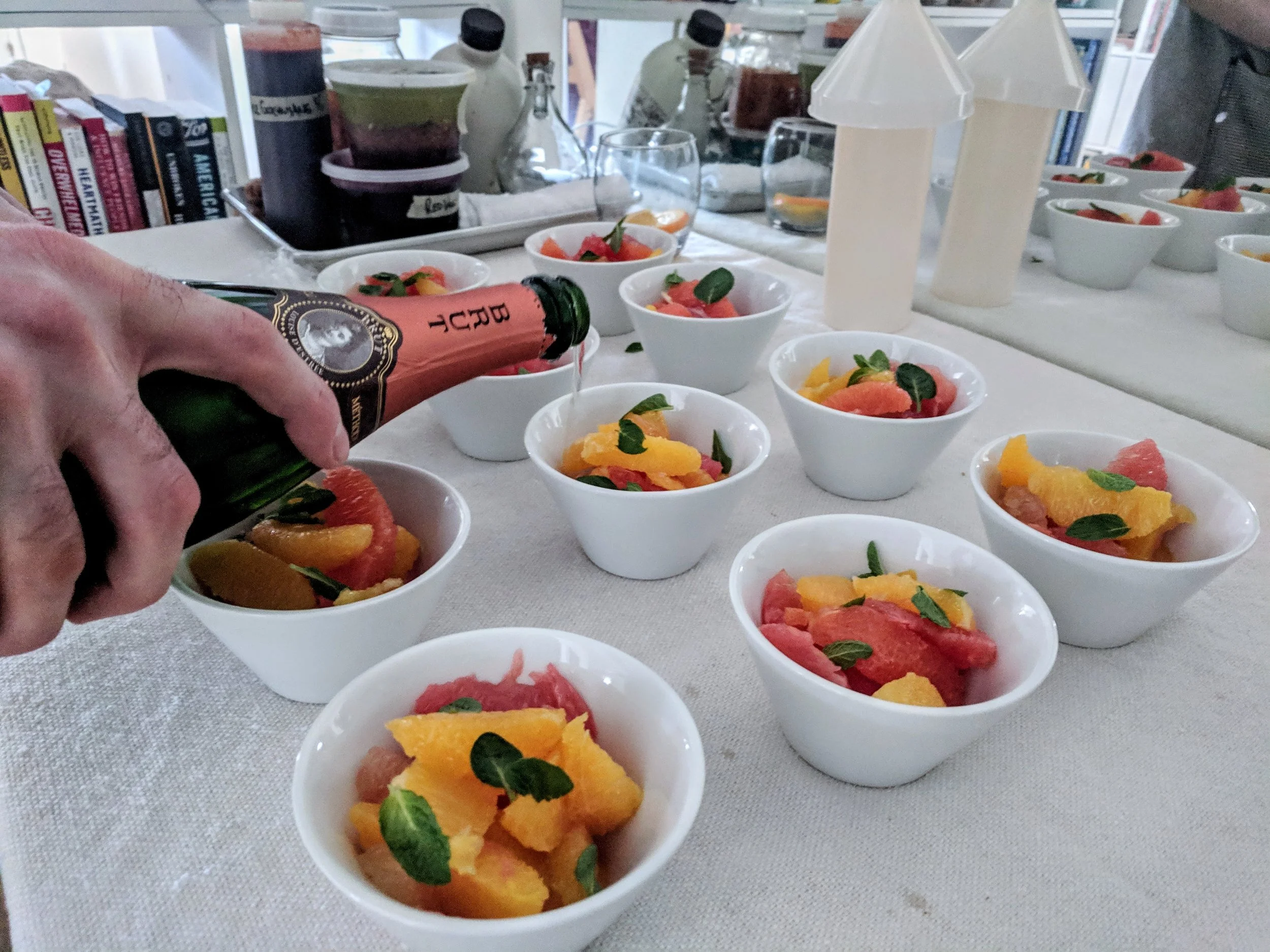 Chef Matthew pouring brut champagne over citrus supremes - private event chef