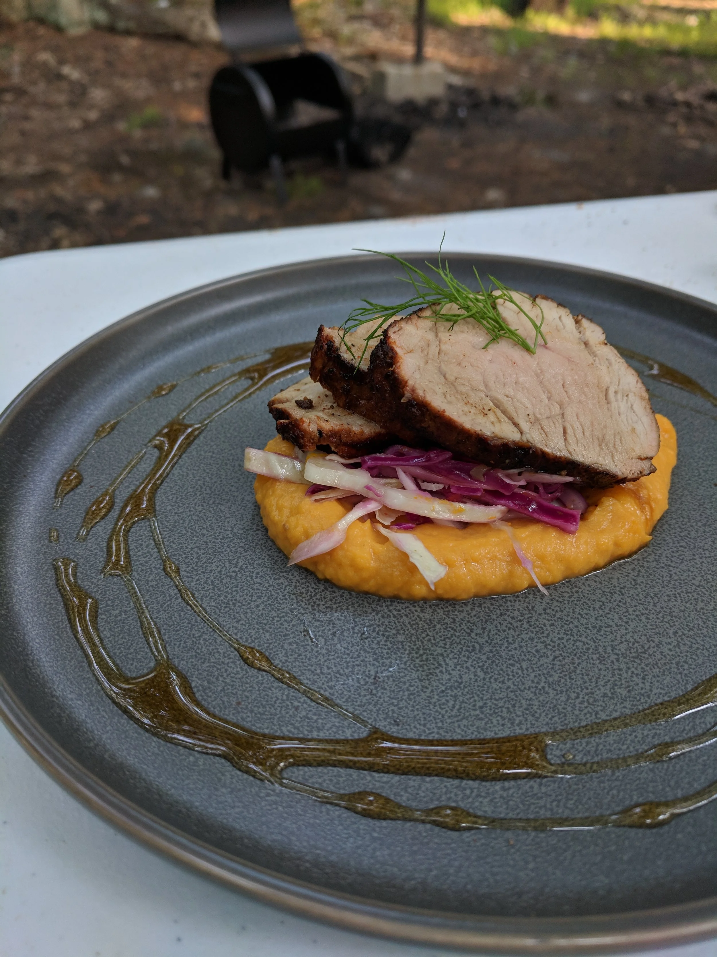 Smoked pork tenderloin over sweet potato and red cabbage with maple glaze