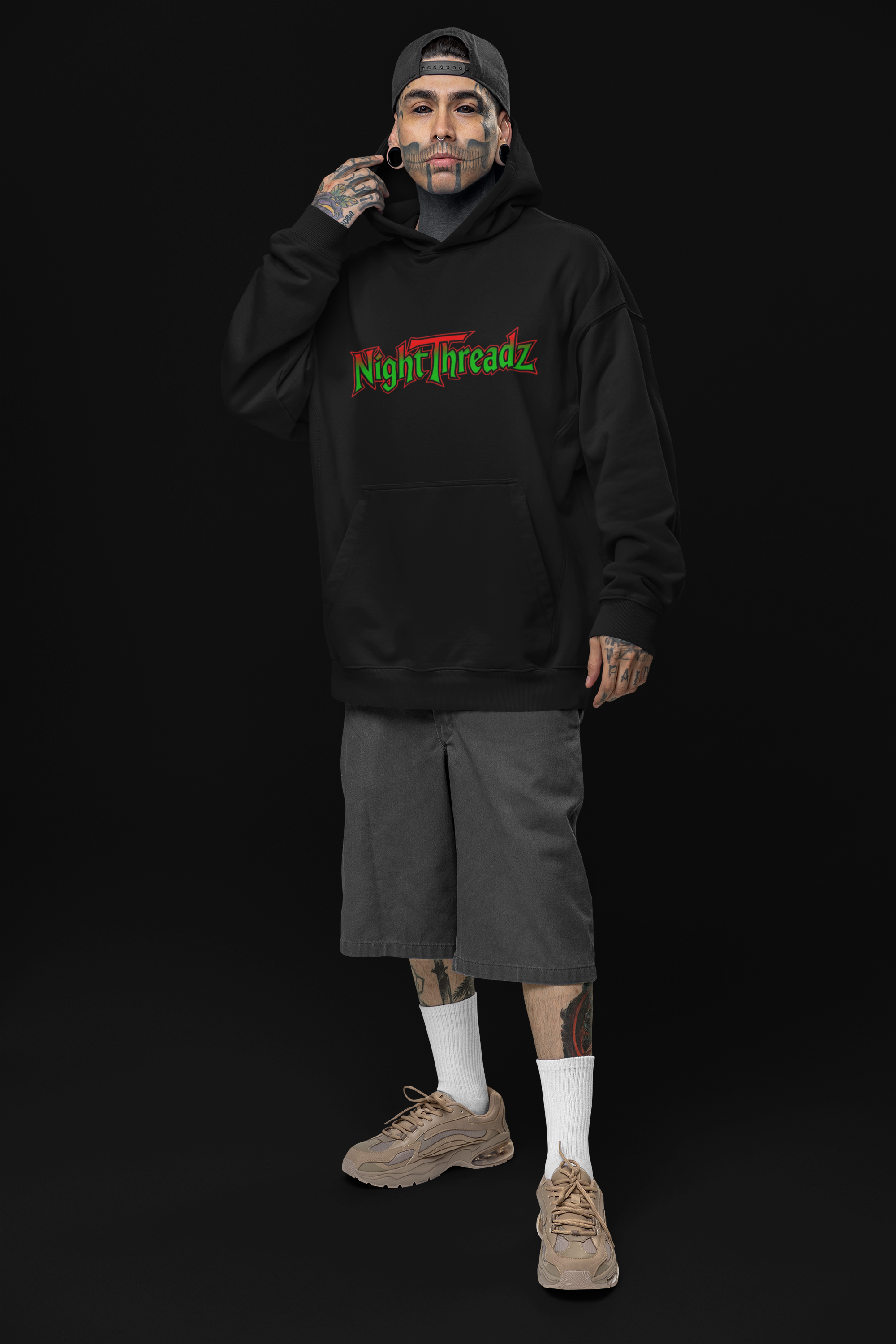 oversized-hoodie-mockup-of-a-tattooed-man-posing-in-a-studio-with-an-alternative-look-m31666.png