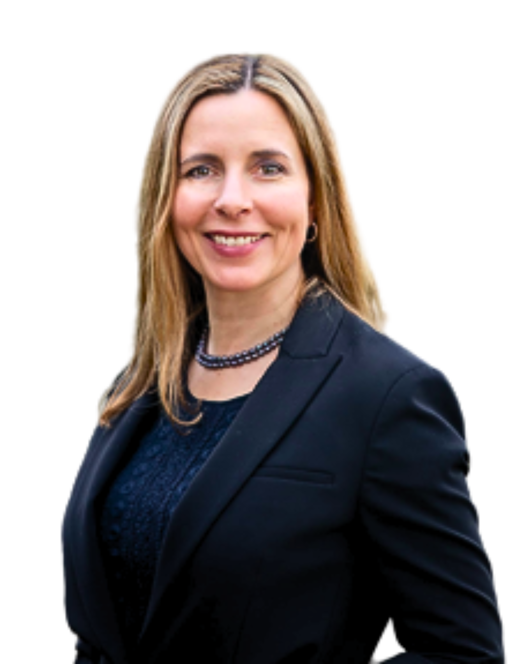 A woman with shoulder-length blonde hair, smiling, wearing a navy blue dress, black blazer, and a pearl necklace, standing outdoors.
