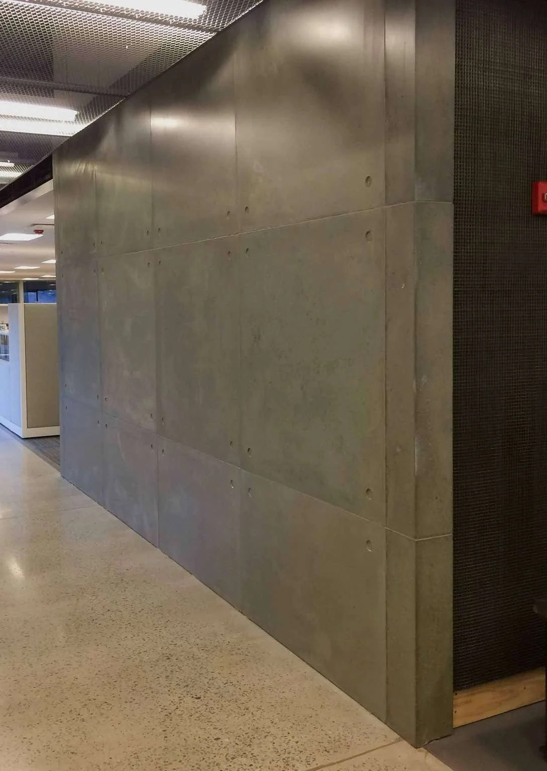 Installed architectural concrete wall panels forming a corridor condition, fabricated by The Concrete Anomaly for Structural Group headquarters.