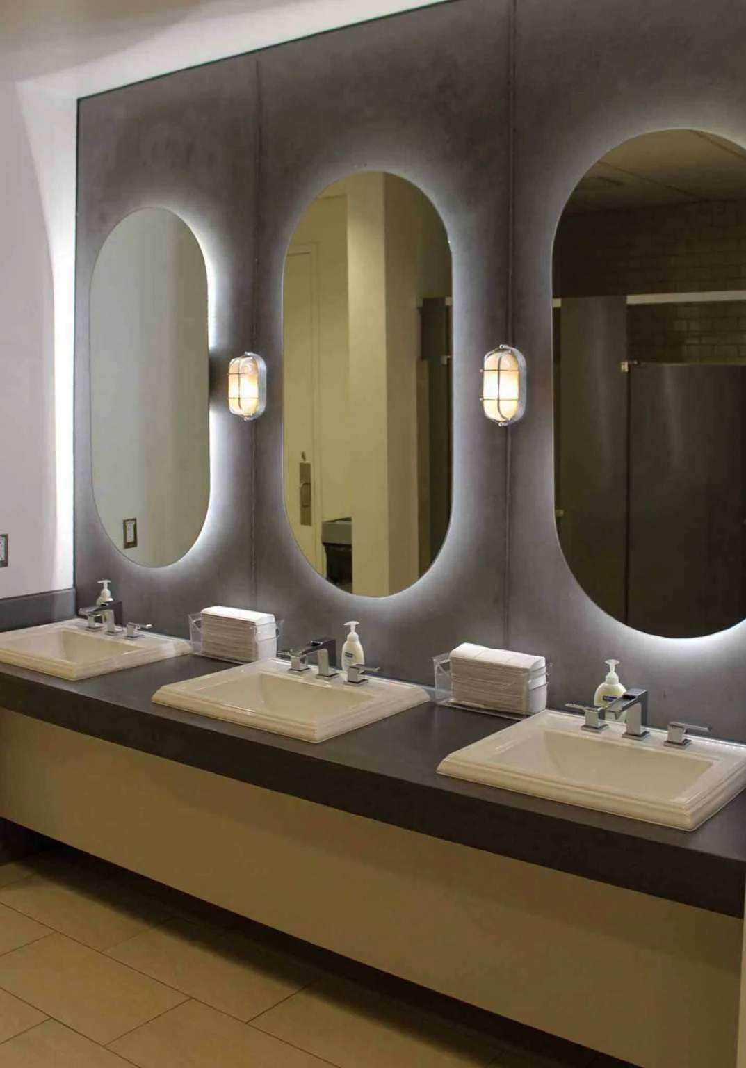 Custom architectural concrete restroom countertop with integrated sinks, fabricated by The Concrete Anomaly for a commercial interior at Structural Group.
