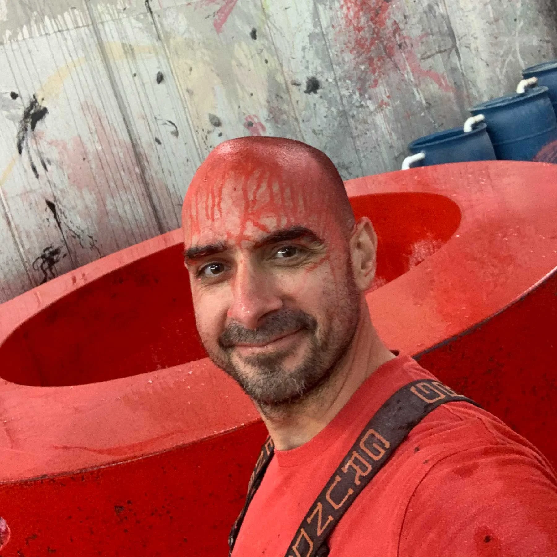 Dylan Myers inside the red concrete letter O during studio fabrication of the monumental LOVE sculpture.
