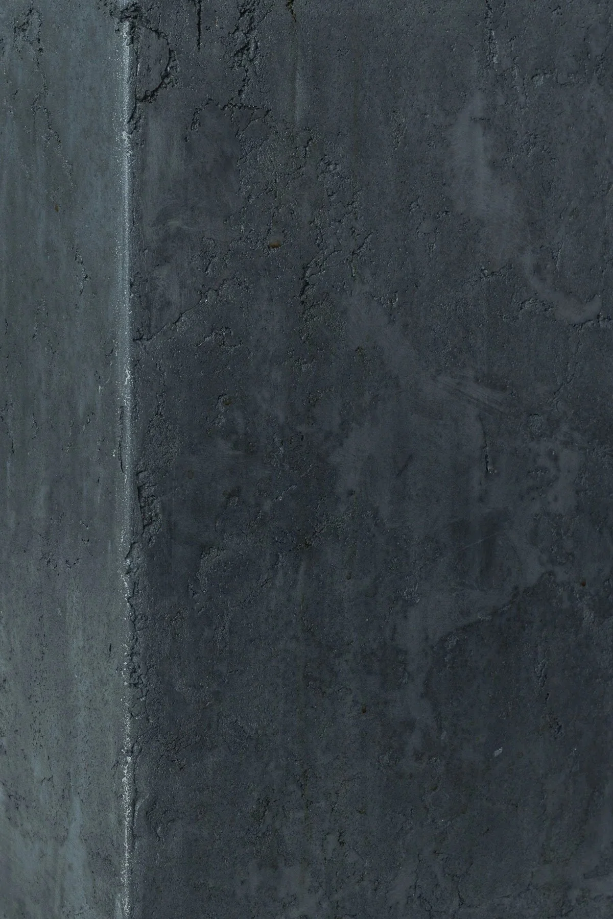 Architectural concrete surface detail showing layered mineral texture, atmospheric tonal variation, and hand-finished material depth by The Concrete Anomaly.
