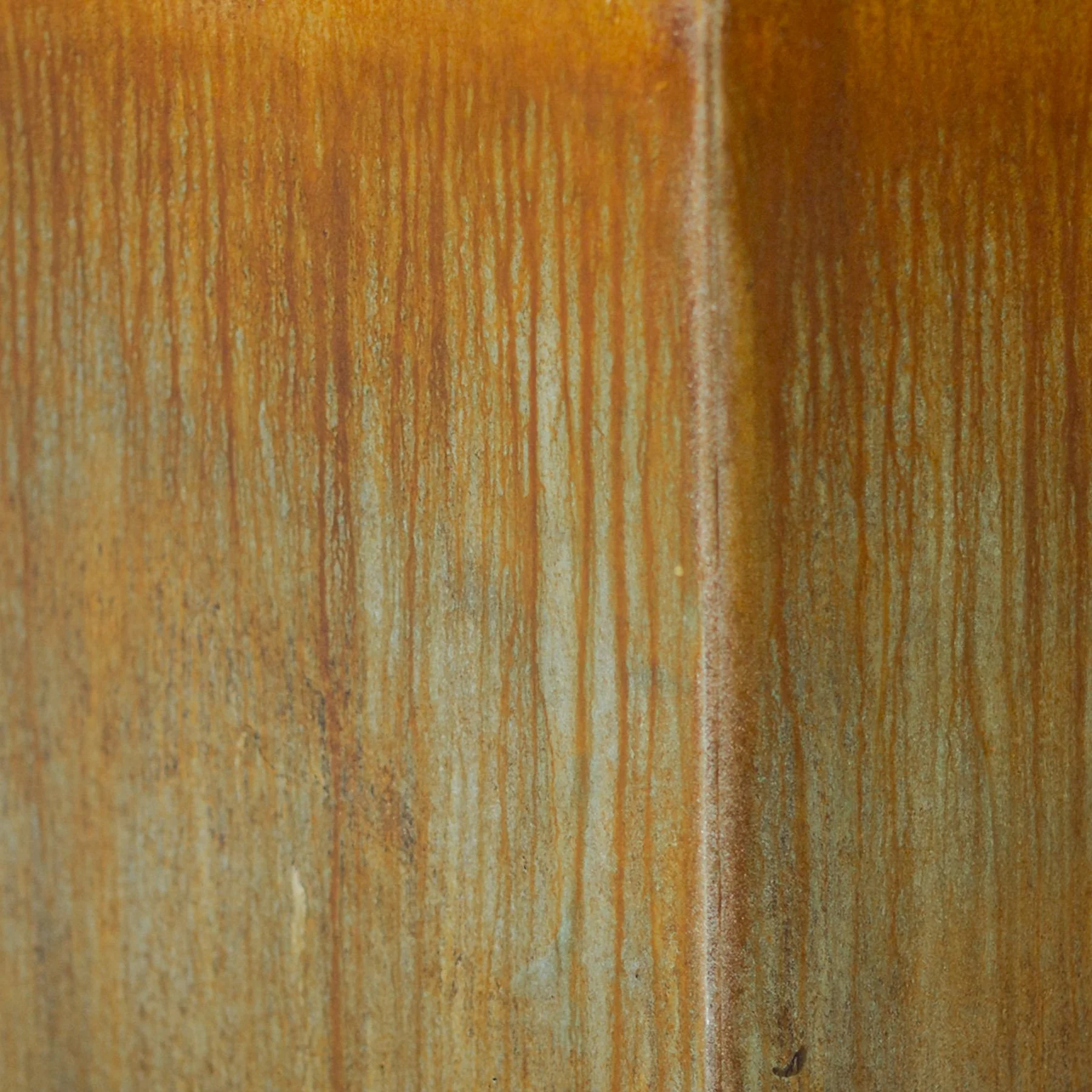 CON-oxd.021 oxidation condition featuring softened rust patina, vertical mineral migration, and atmospheric tonal variation across an architectural concrete surface.