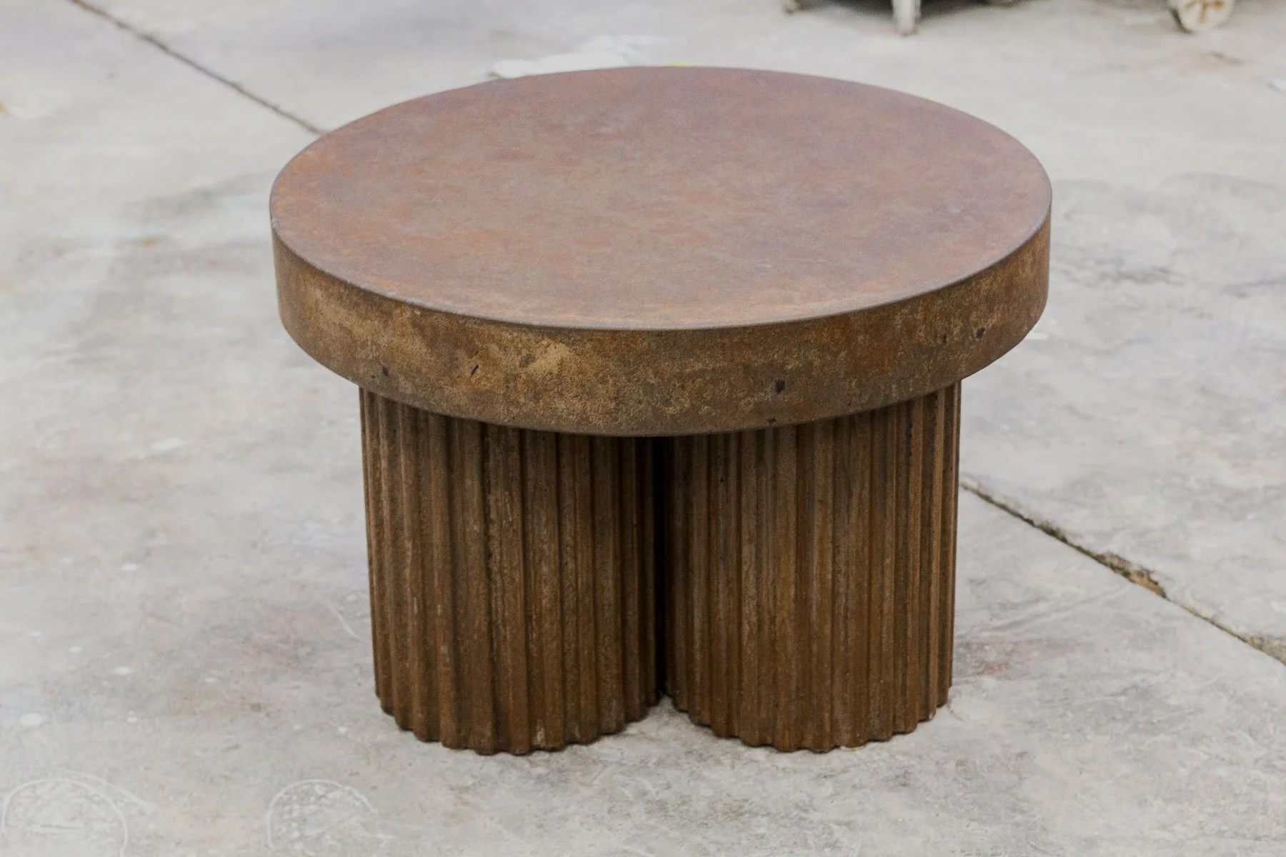 Fluted Tobacco concrete side table by The Concrete Anomaly featuring a hand-finished tobacco patina and sculptural fluted base.
