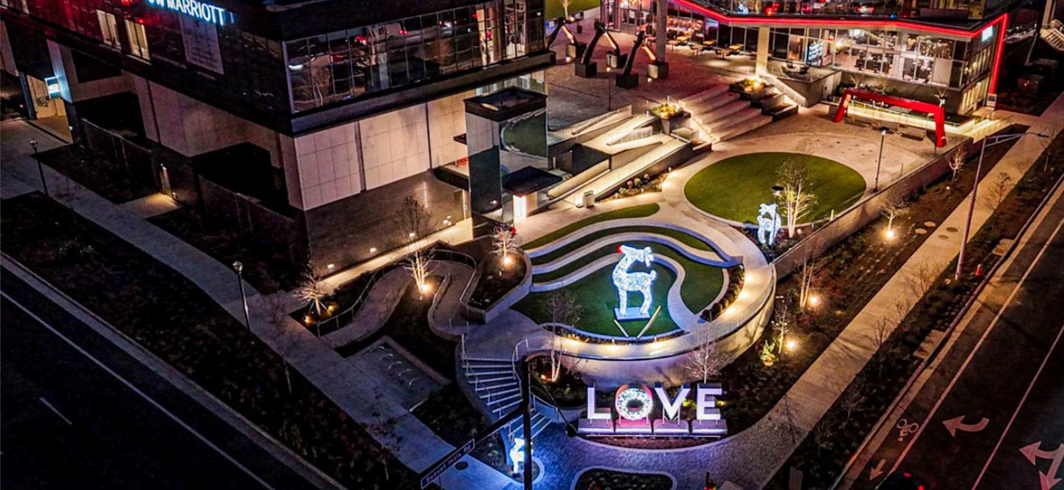 Aerial night view of the LOVE concrete sculpture installation at Reston Station plaza by The Concrete Anomaly.