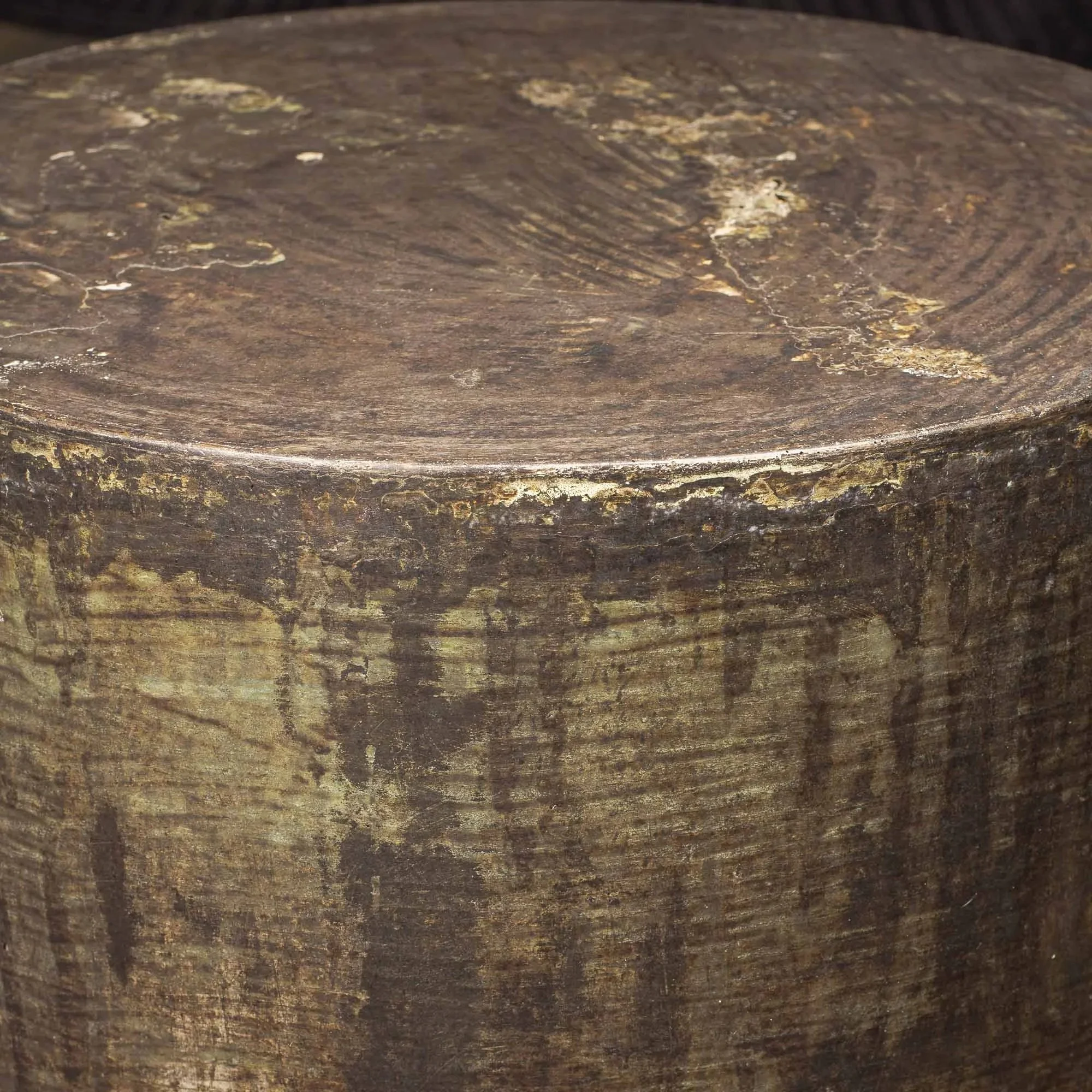 Detail photograph revealing layered acid patina, oxidized edge wear, and textured concrete surface movement across the tabletop.