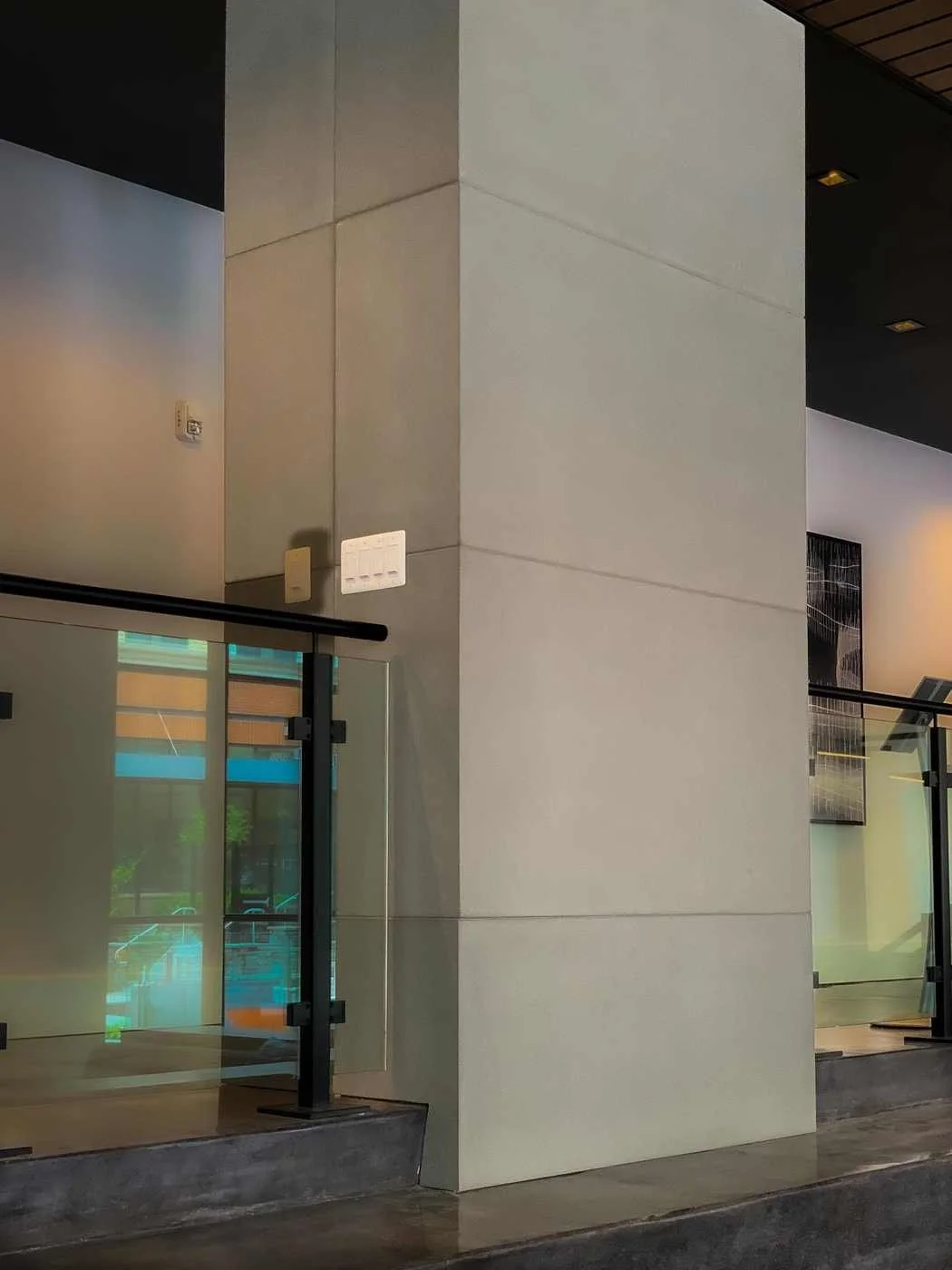 Custom cast concrete wall and column wraps installed as architectural elements within a contemporary commercial space.