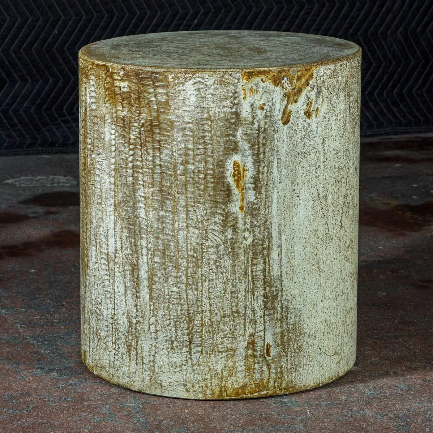 Hand-formed ochre concrete side table from Line ZERO featuring atmospheric mineral movement and aged surface detailing
