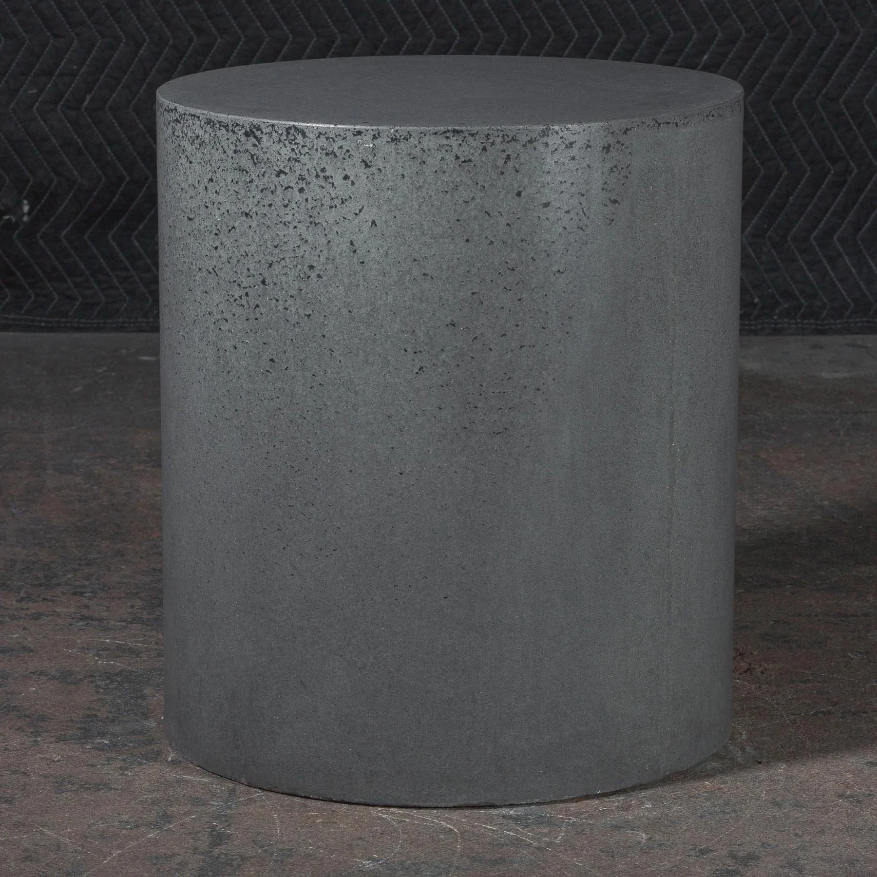 Sculptural concrete pedestal with quiet matte grey finish and softened industrial character designed for contemporary architectural interiors.