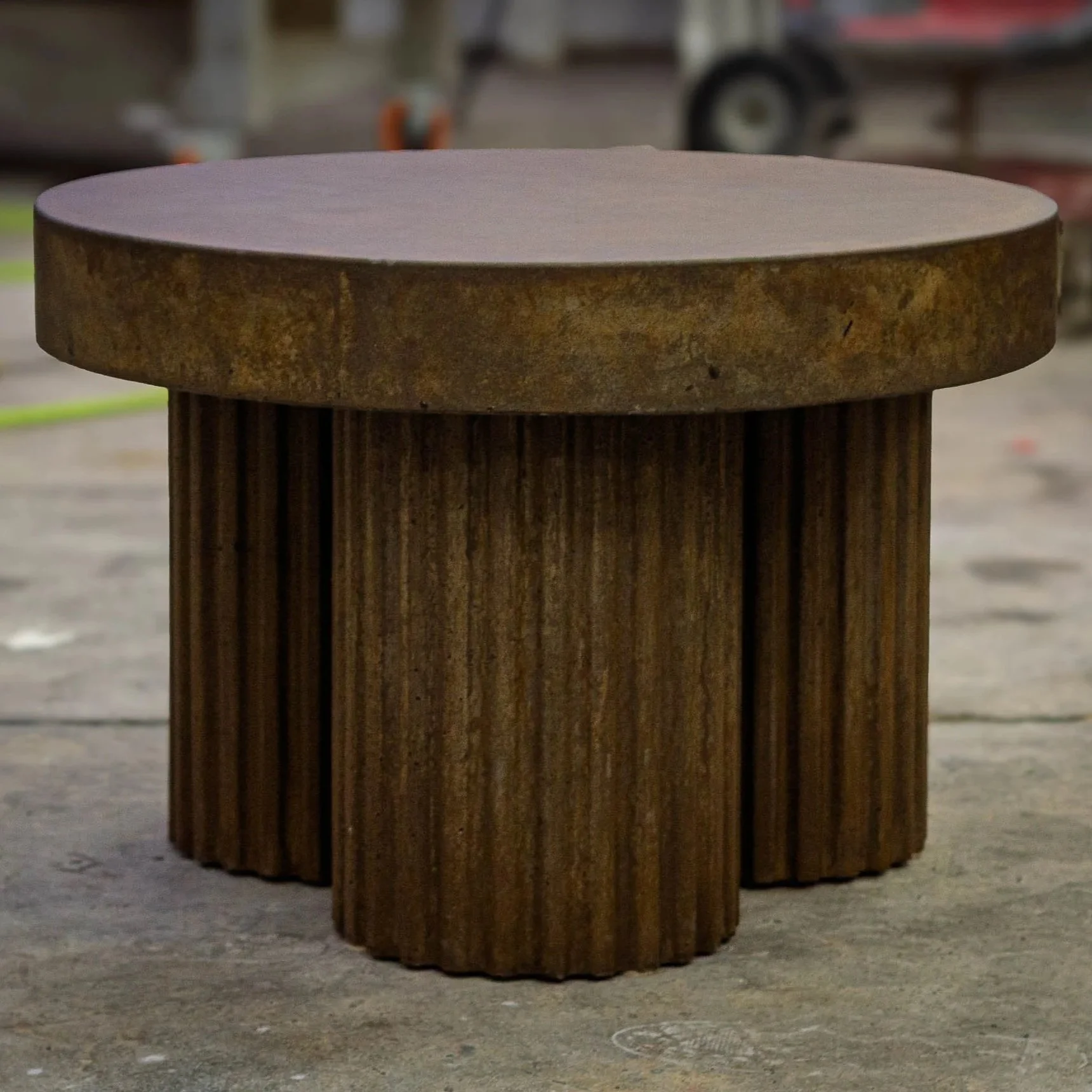Fluted Tobacco concrete side table with vertically fluted base and weathered tobacco-toned finish by The Concrete Anomaly.