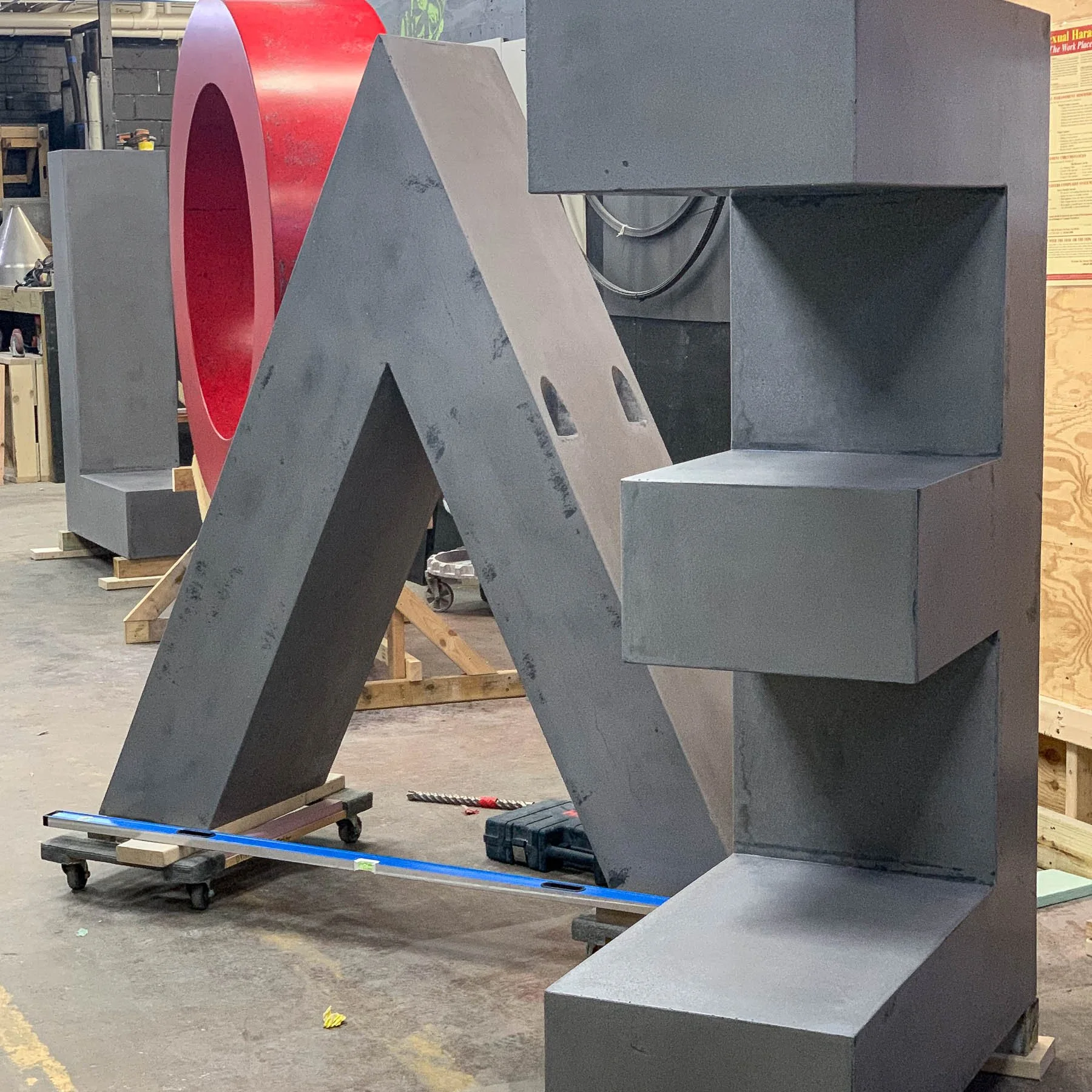 Monumental concrete letter components for the LOVE public artwork arranged in The Concrete Anomaly’s Maryland studio.