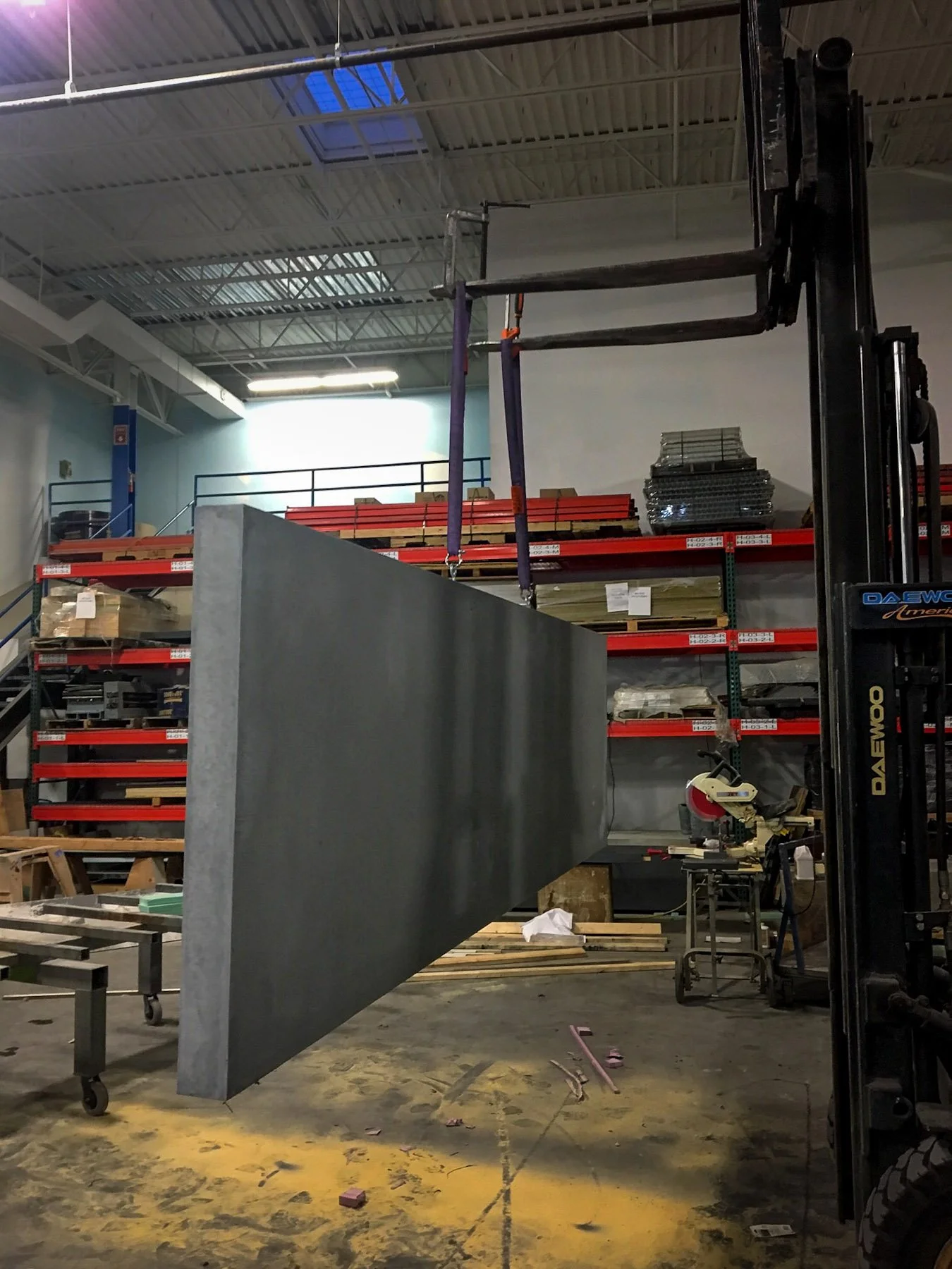 Large-scale architectural concrete panel suspended during fabrication prior to installation for exterior rooftop hospitality project.