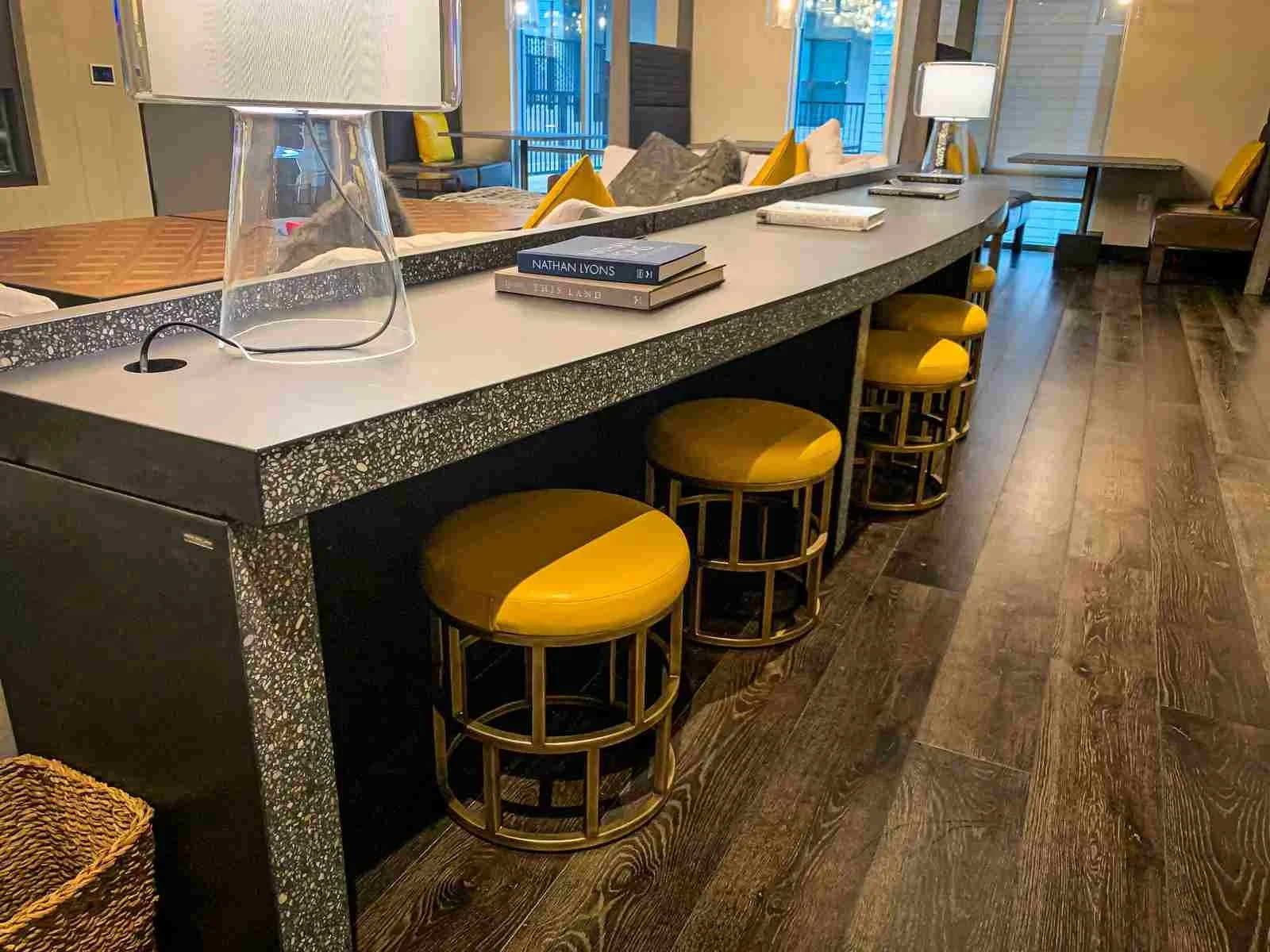 Custom turnkey concrete desk with monolithic waterfall edges and honed aggregate surface, designed and fabricated by The Concrete Anomaly for a commercial interior.