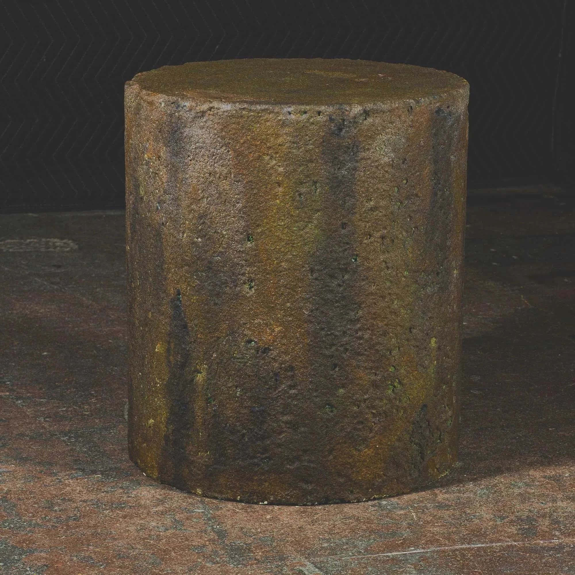 Hand-cast GFRC concrete cylinder with heavy oxidation finish, vertical mineral streaking, and weathered industrial texture from The Concrete Anomaly.