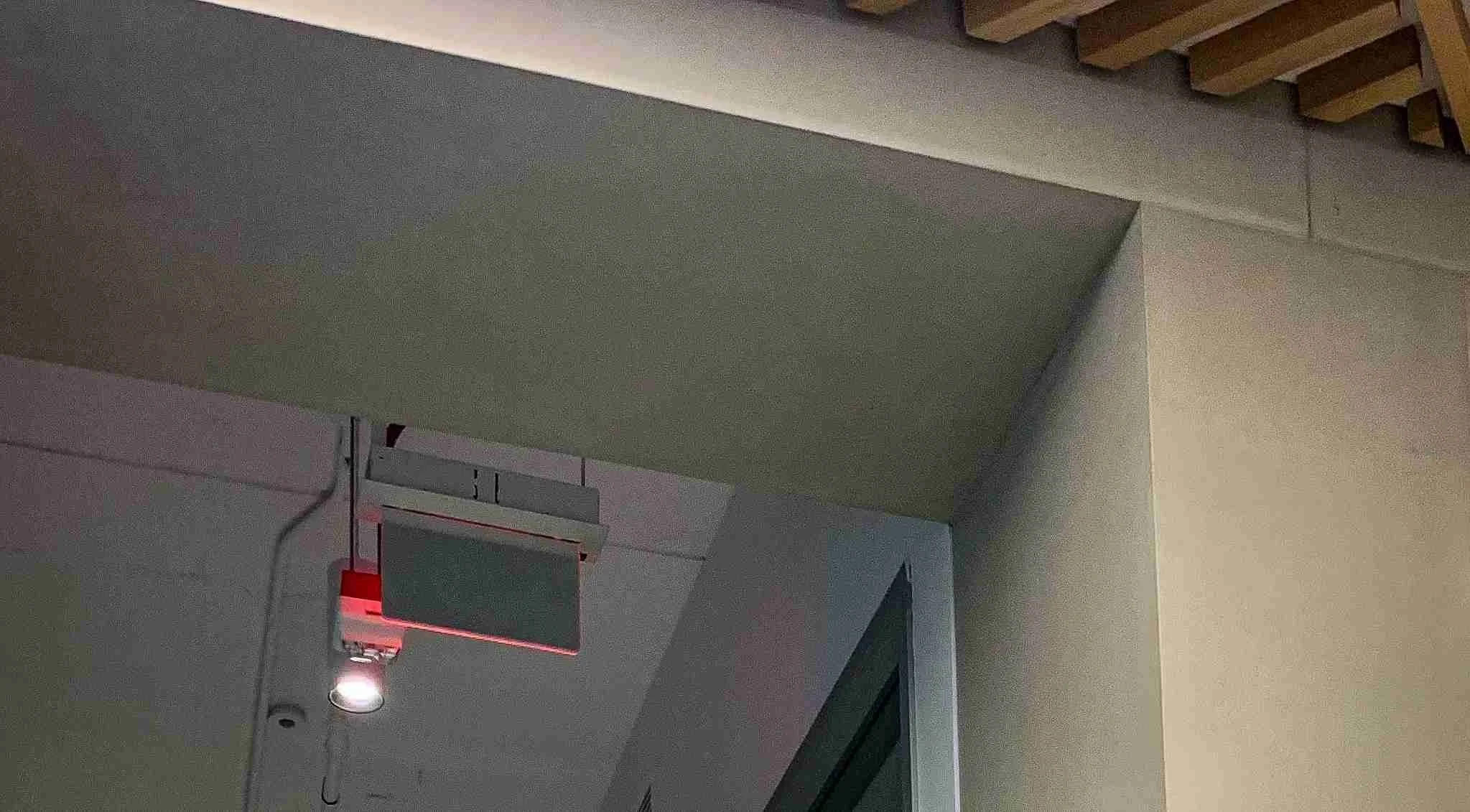 Concrete wall and ceiling interface detail with integrated lighting and sensor