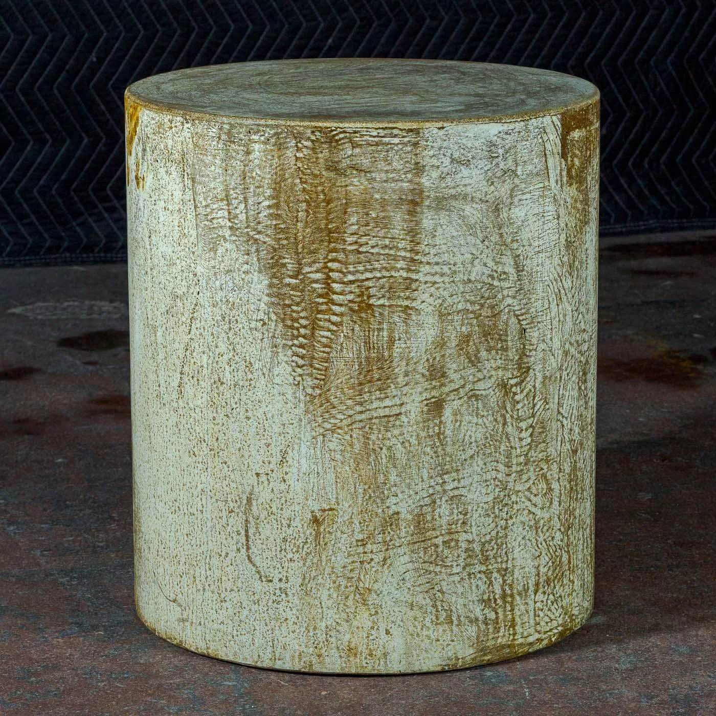 Sculptural ochre concrete side table with textured mineral surface and softened erosion patterns by The Concrete Anomaly