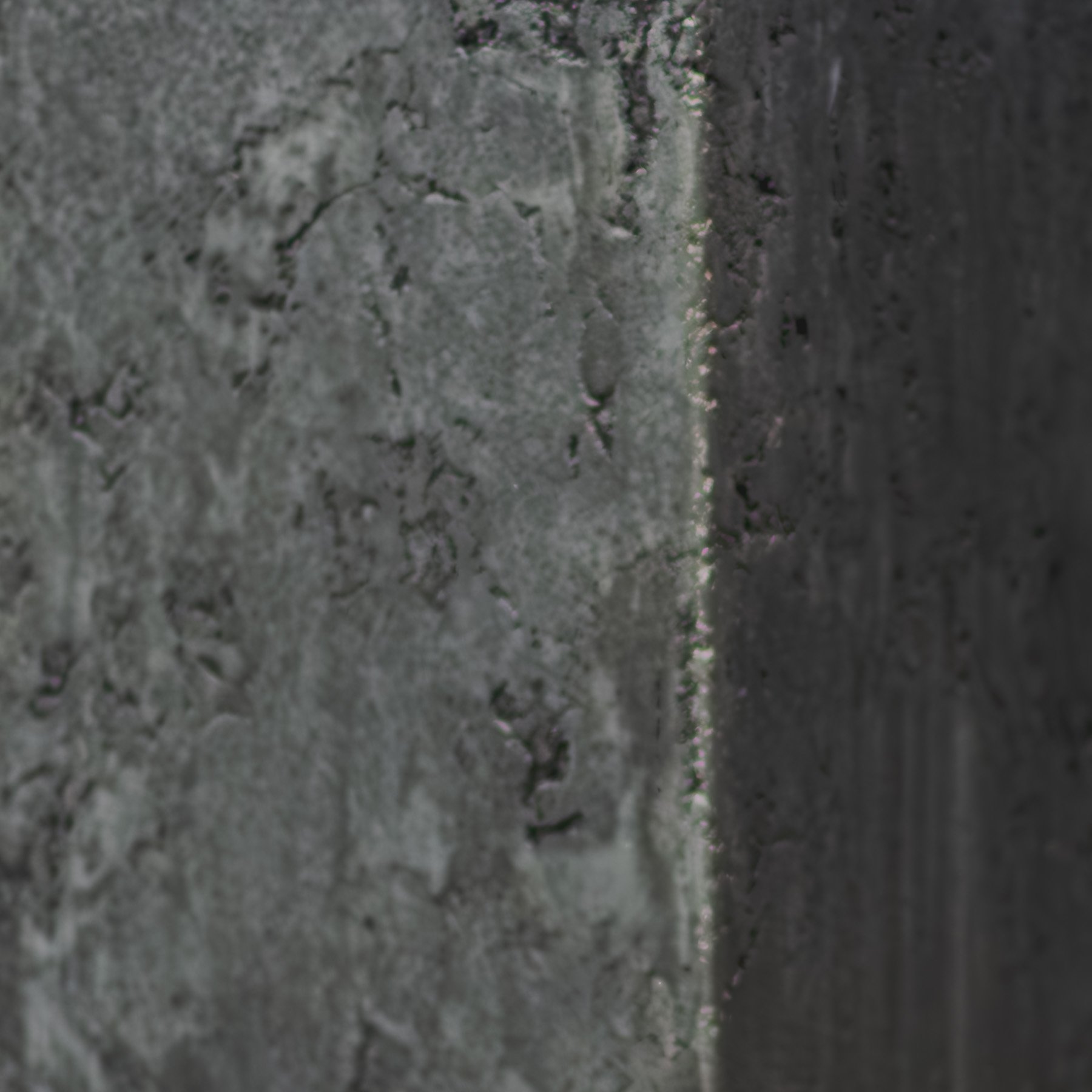 Raw strata condition showing layered gray mineral deposits, surface variation, and accumulated material depth.