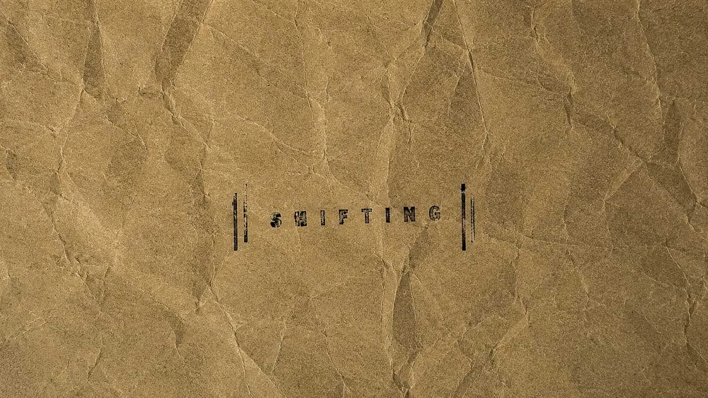 Crumpled kraft paper with distressed "SHIFTING" stamp representing evolving conditions, future discoveries, and ongoing material investigations.