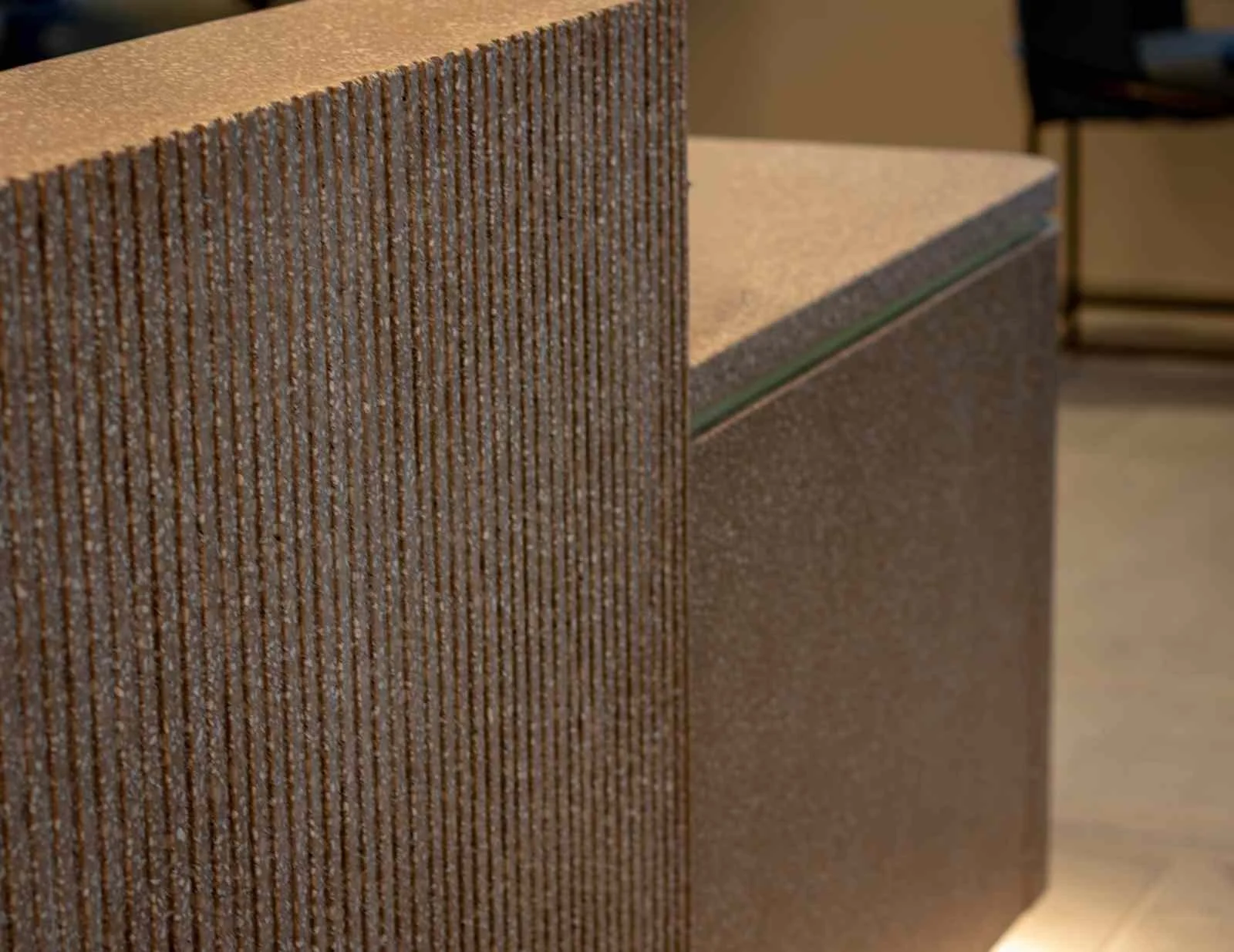 Close-up of a textured cast concrete panel with linear relief and clean corner detailing.