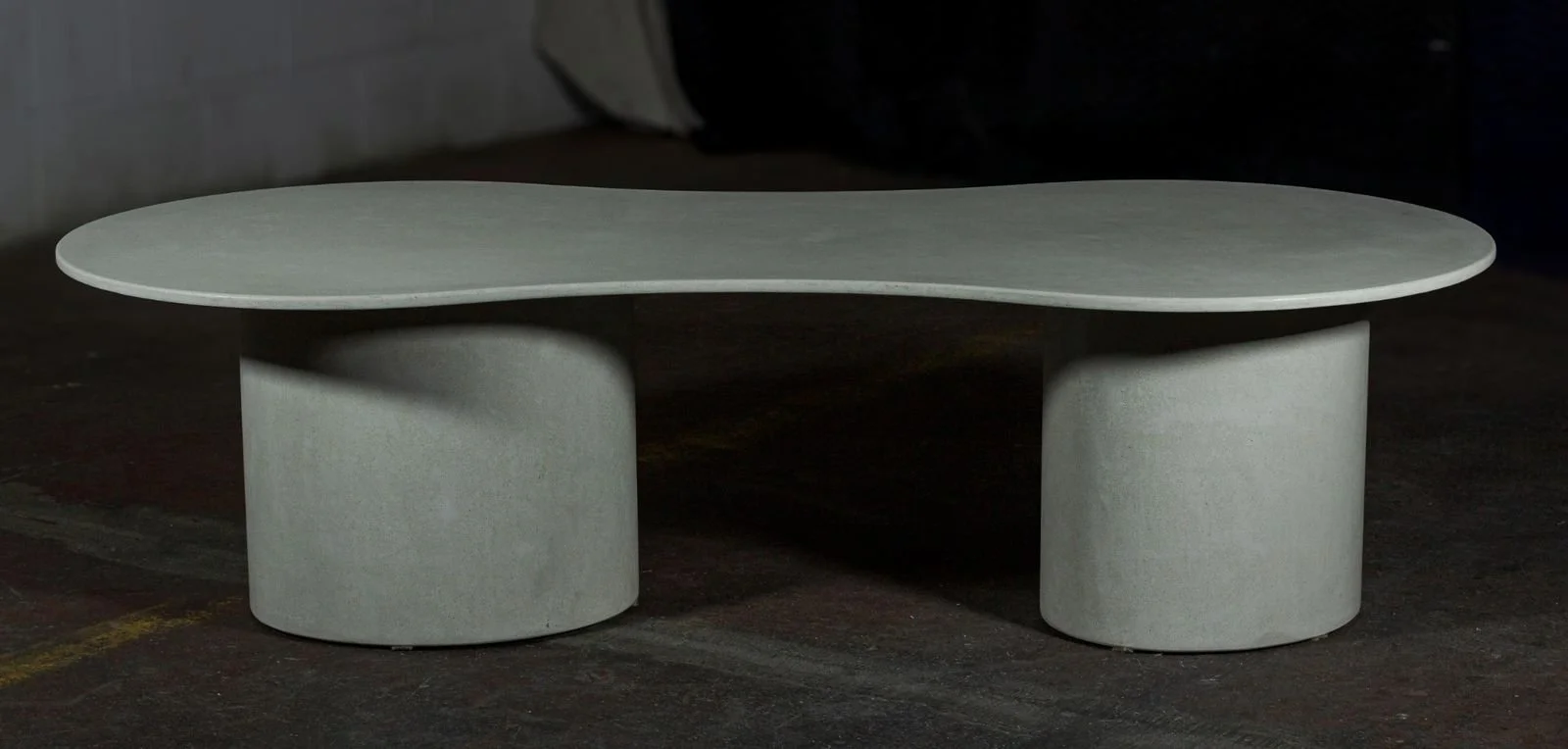 Ovalation ONE sculptural concrete coffee table with monolithic curved form by The Concrete Anomaly.