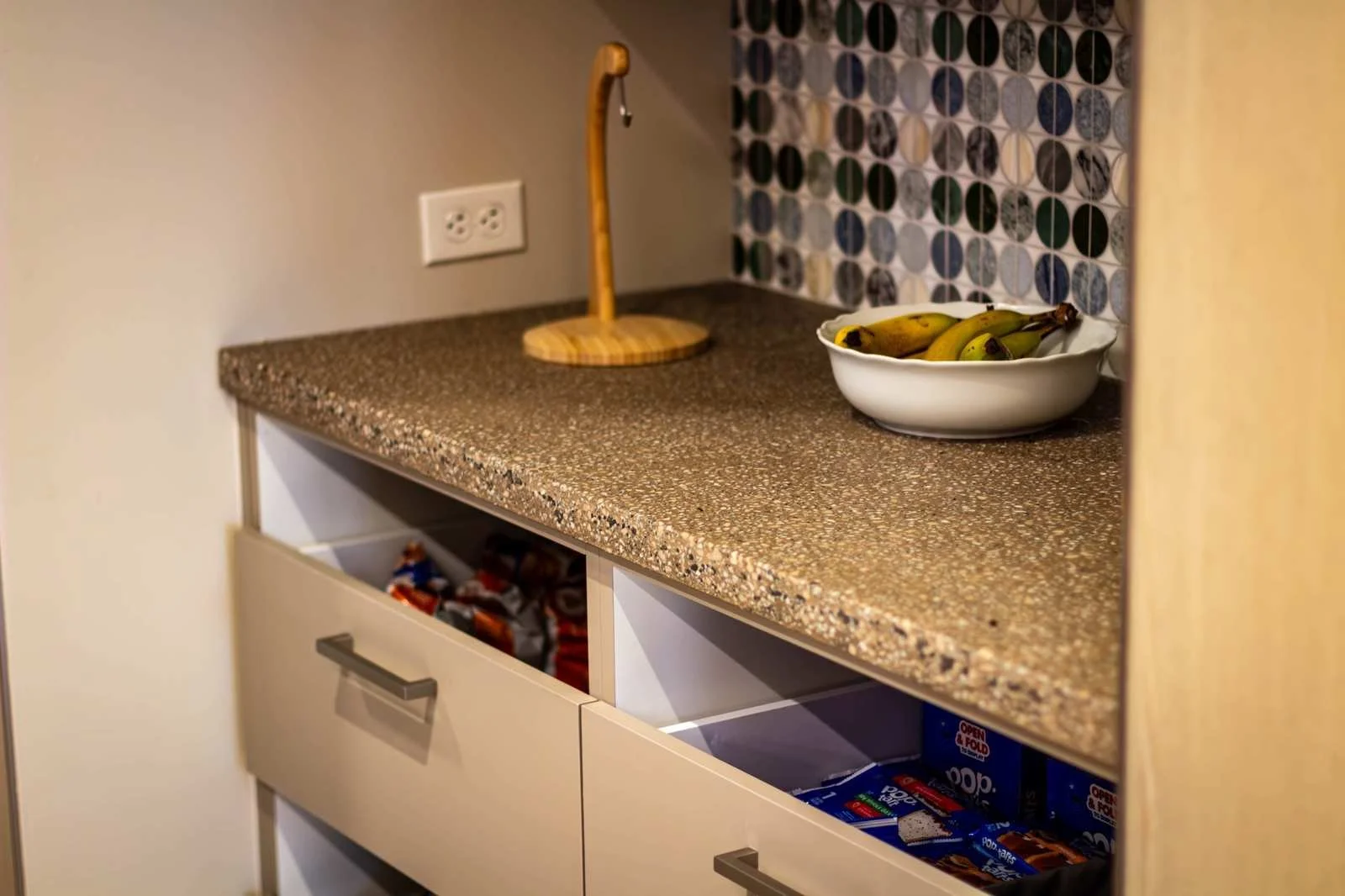 Custom cast concrete countertop with integrated aggregate surface installed in a functional kitchen environment.