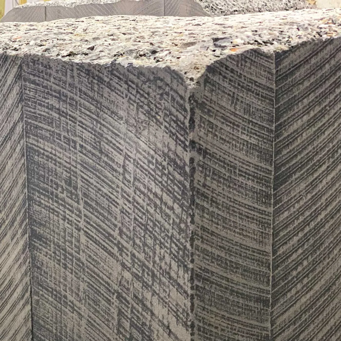 Close-up of the precisely textured concrete corner and layered surface pattern of the monumental LOVE sculpture.