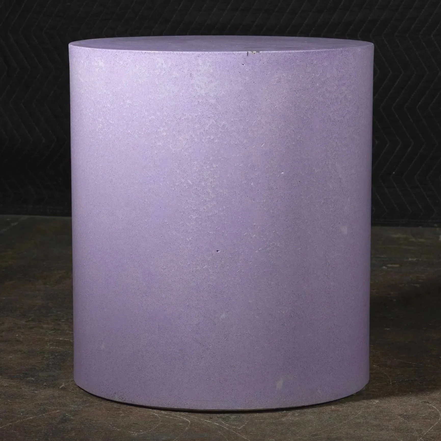 Hand-cast GFRC concrete cylinder featuring soft violet mineral tones and refined monolithic surface texture.