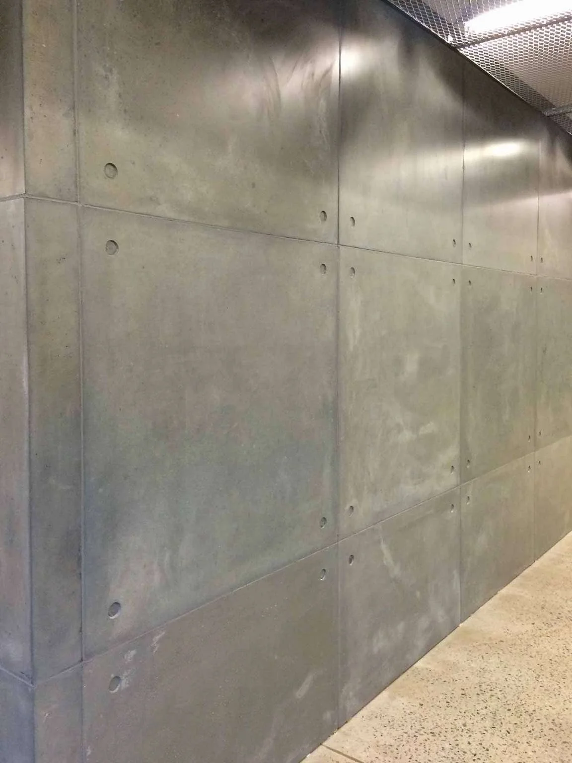 Monolithic architectural concrete wall panels with exposed fastener detailing, designed and fabricated by The Concrete Anomaly for Structural Group.