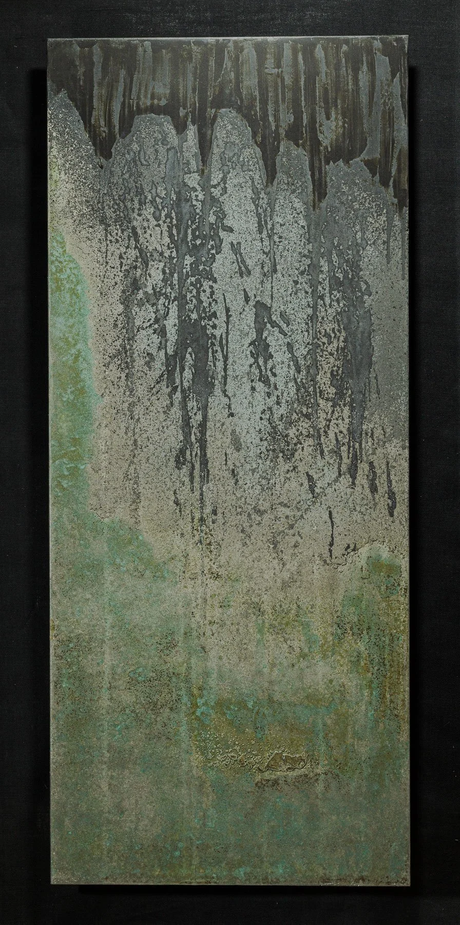 Vertical concrete artifact panel with oxidized mineral textures and layered black patina
