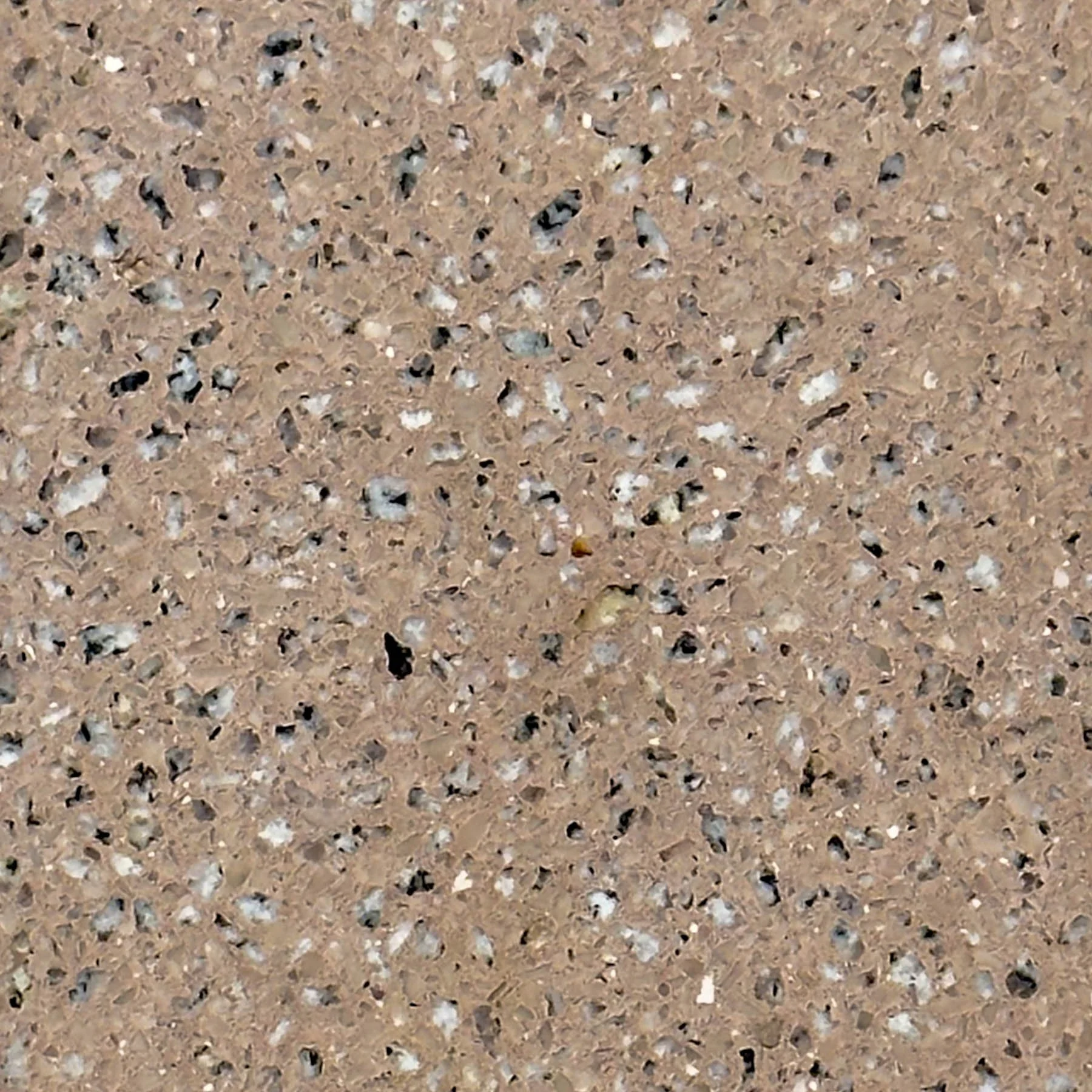 Close-up of handcrafted terrazzo concrete featuring warm earth tones and exposed aggregate by The Concrete Anomaly.