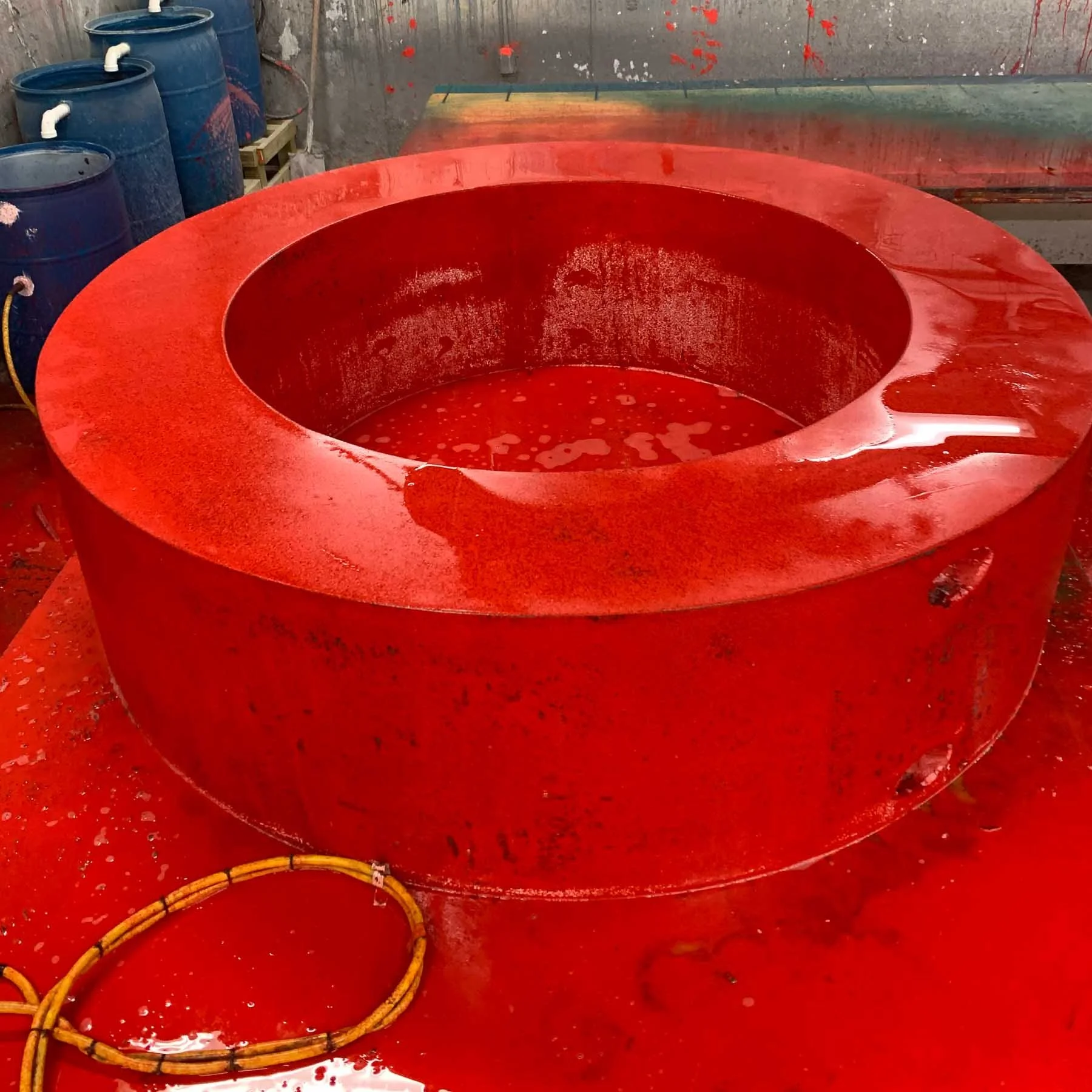 Red-pigmented concrete letter O curing in its casting mold during fabrication of the monumental LOVE sculpture.