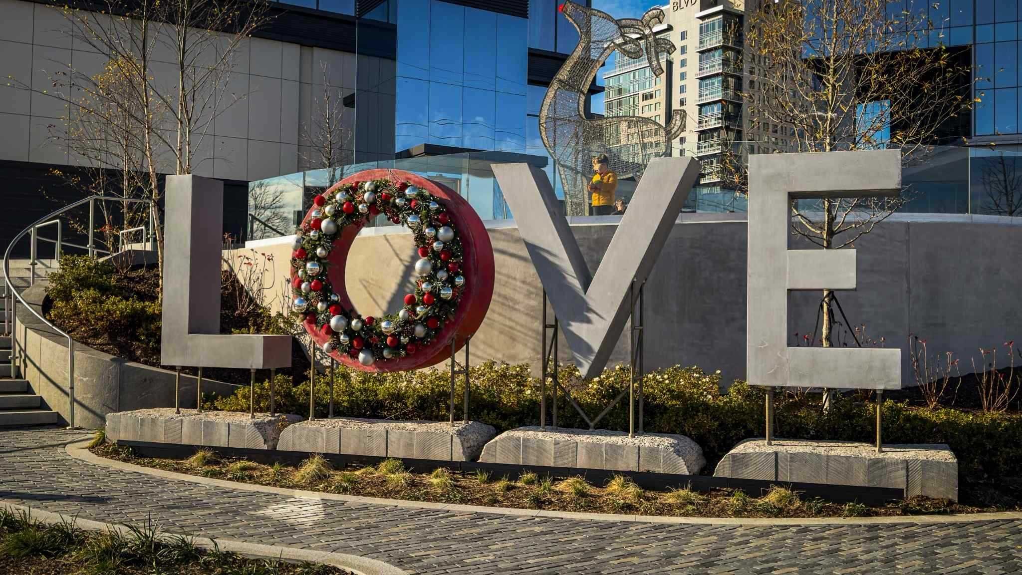 Monumental LOVE concrete sculpture installation at Reston Station by The Concrete Anomaly.