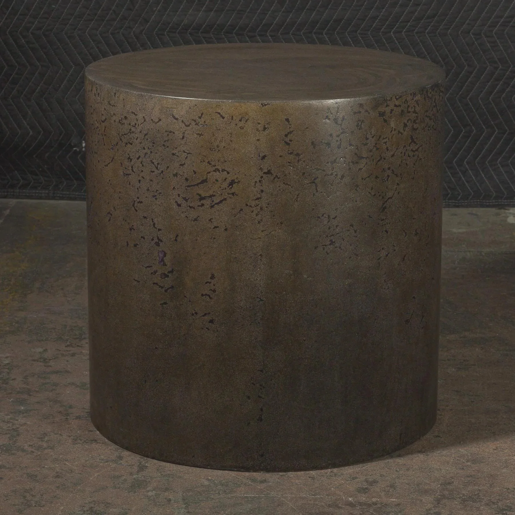 Dark bronze concrete side table with weathered metallic patina and cylindrical sculptural form by Dylan Myers.