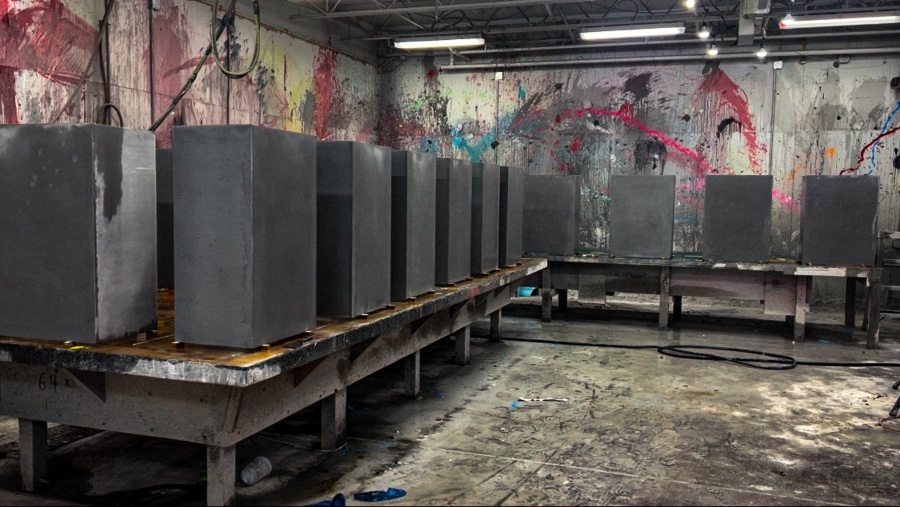 Prefabricated concrete column wrap systems staged during fabrication.