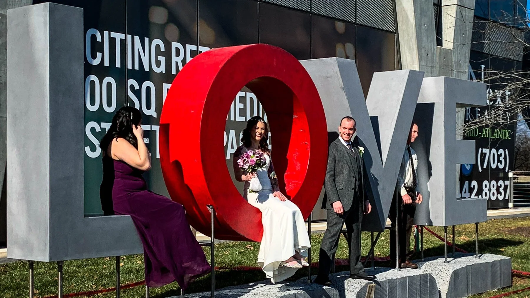 Wedding party posing with Dylan Myers’ monumental Then LOVE Emerges concrete sculpture at its original Reston Station location in Reston, Virginia.