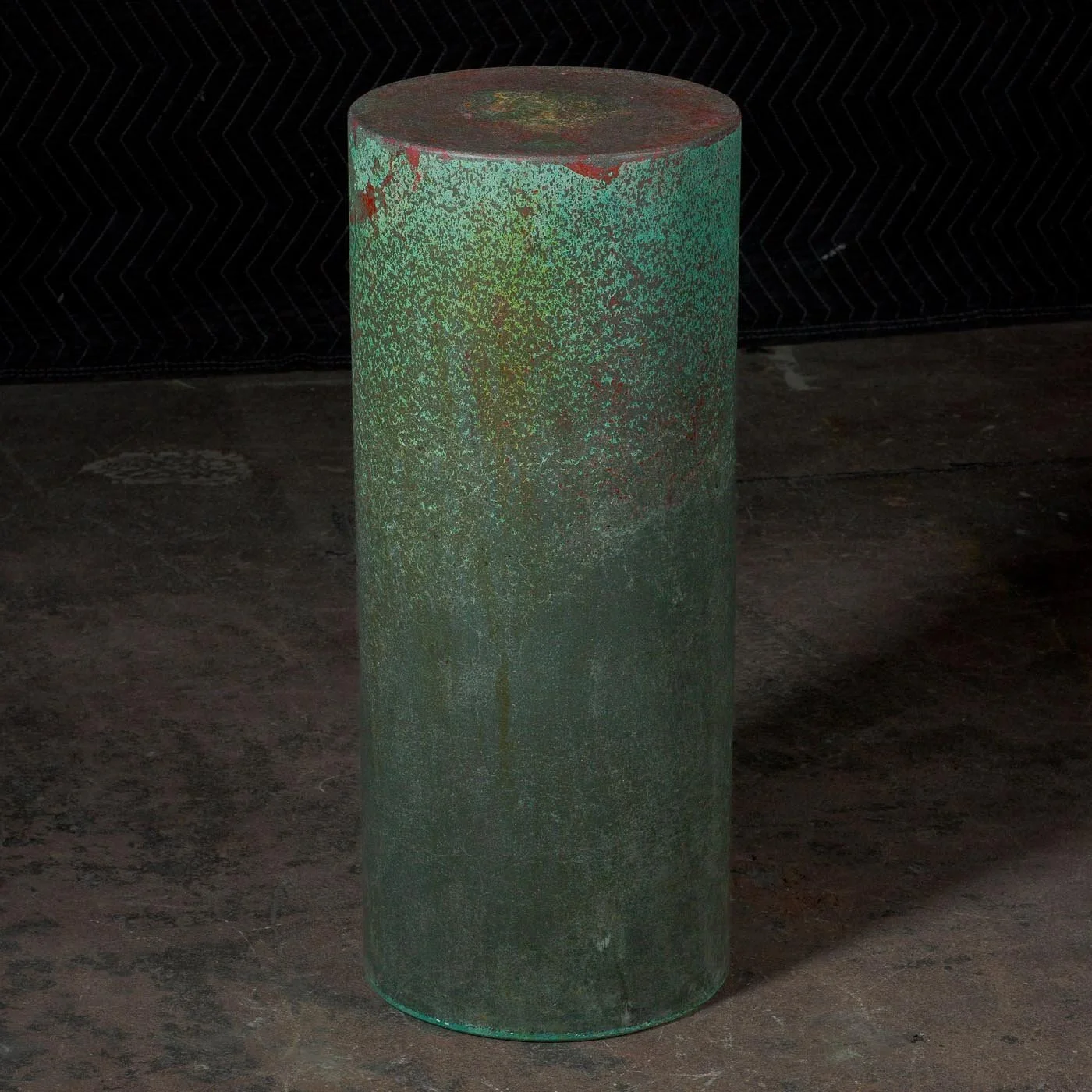 Oxidized green concrete cylinder with layered mineral texture and weathered architectural surface from The Concrete Anomaly Line ZERO series
