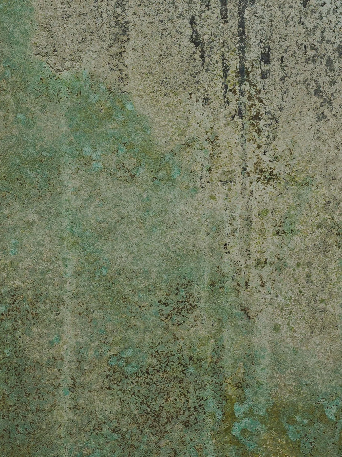 Oxidized concrete artifact surface with layered mineral textures and green patina
