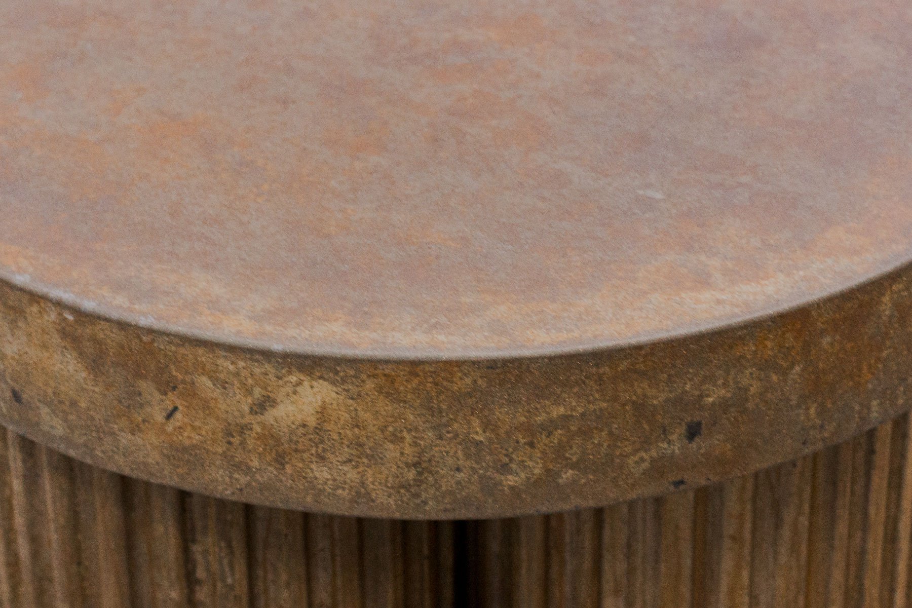 Detailed view of the layered mineral finish, weathered edge transitions, and tactile concrete surface characteristics.