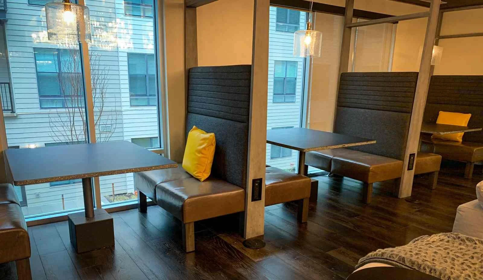 Custom architectural concrete divider panels fabricated by The Concrete Anomaly, integrated into booth seating in a commercial hospitality interior.