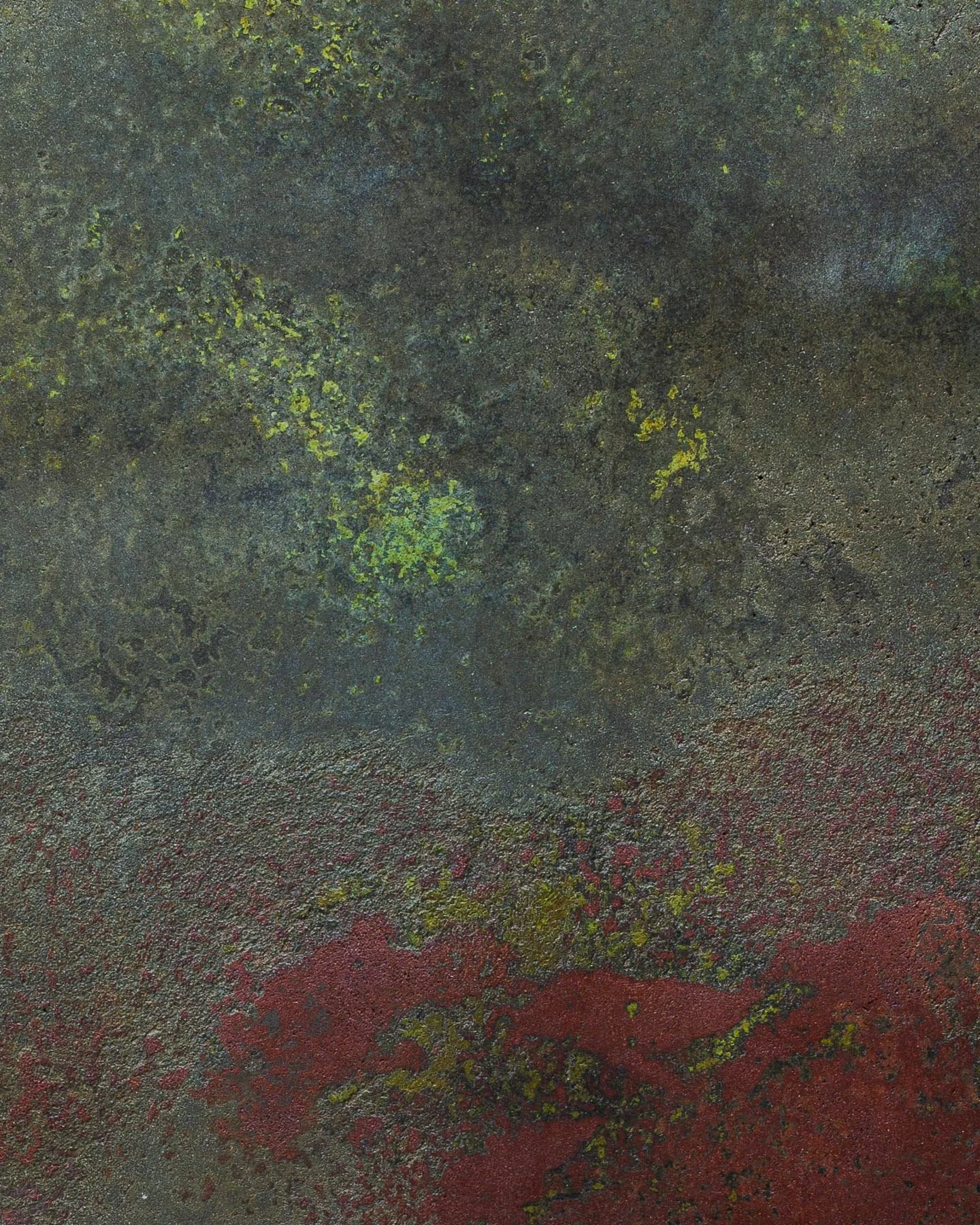 Weathered concrete artifact surface with layered red pigment, oxidized texture, and mineral depth