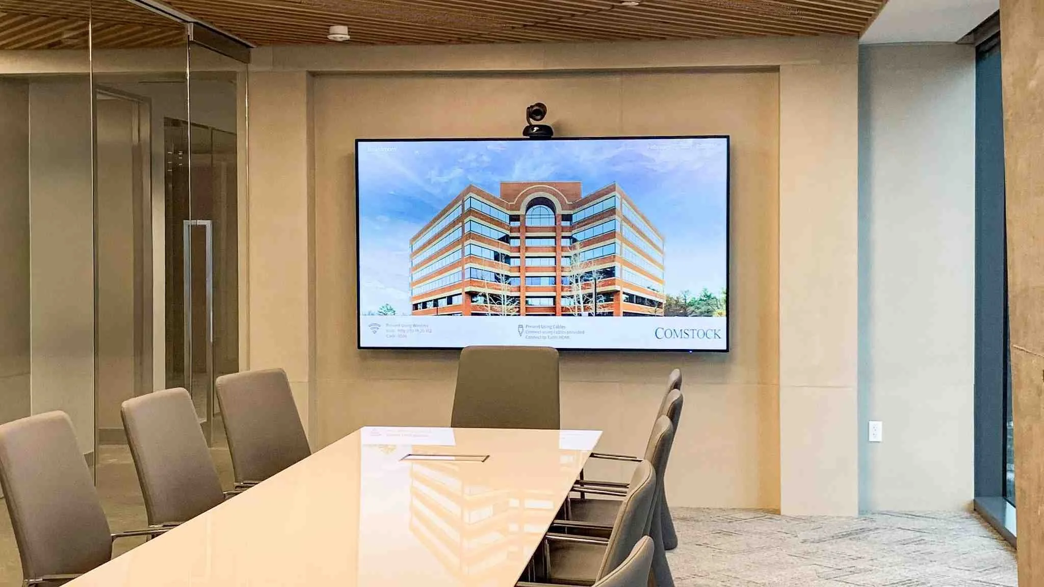 Concrete-clad column wraps integrated into a modern conference room, coordinating with adjacent wall systems.