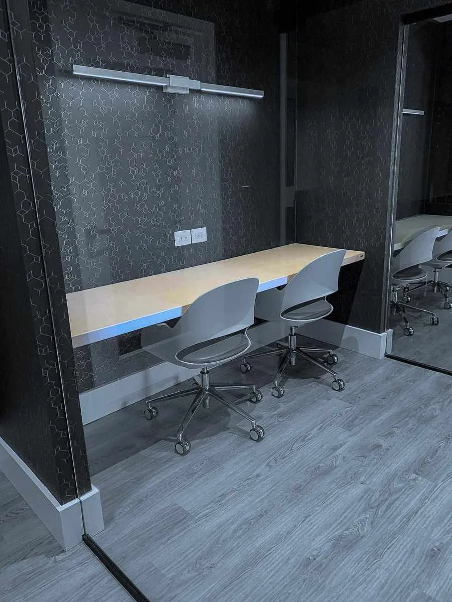Custom cast concrete office workstation with integrated desk and textured architectural wall panels.