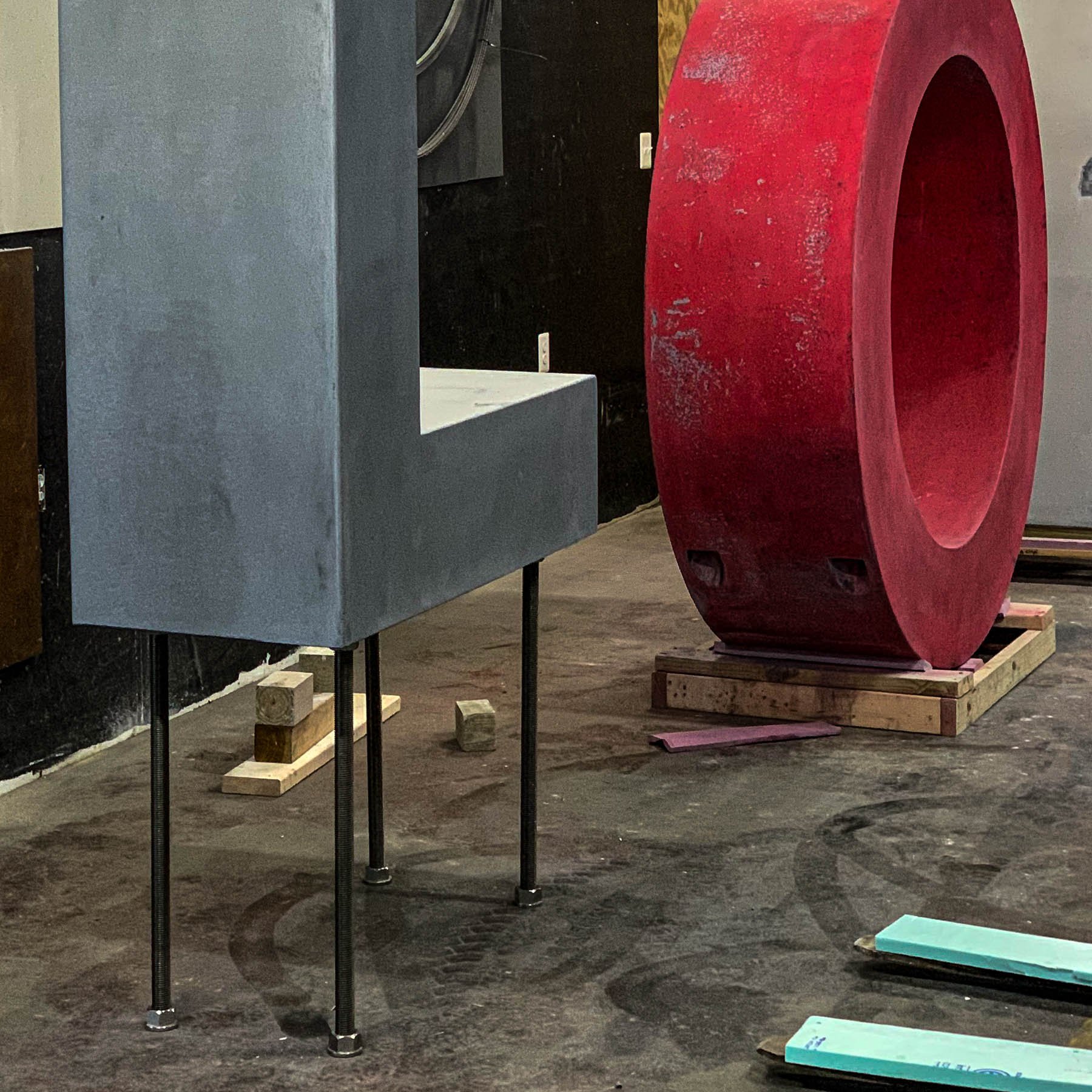 Concrete letter components of the monumental LOVE sculpture arranged inside The Concrete Anomaly’s Maryland studio.
