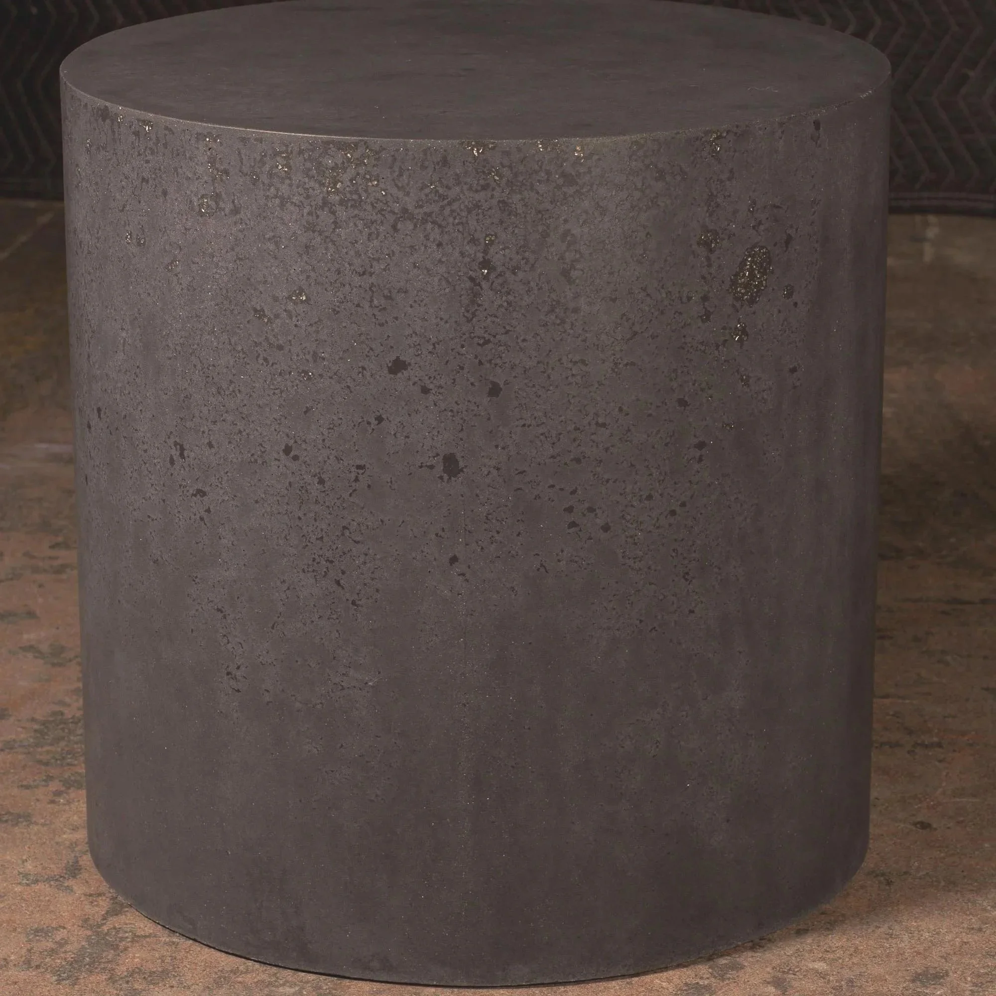 Minimal dark concrete pedestal side table featuring monolithic geometry, muted texture, and atmospheric industrial character.