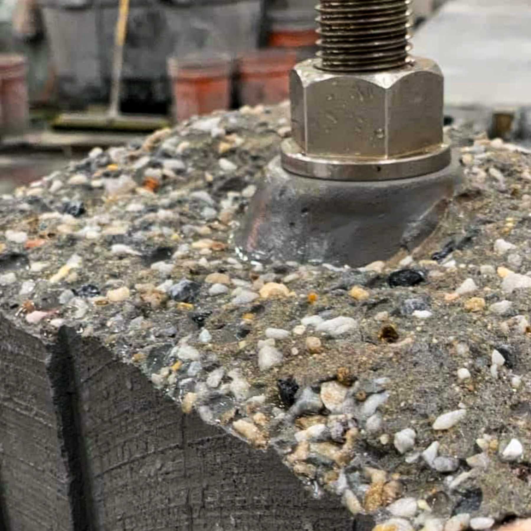 Stainless-steel threaded support hardware mocked up in exposed aggregate concrete for the LOVE sculpture.