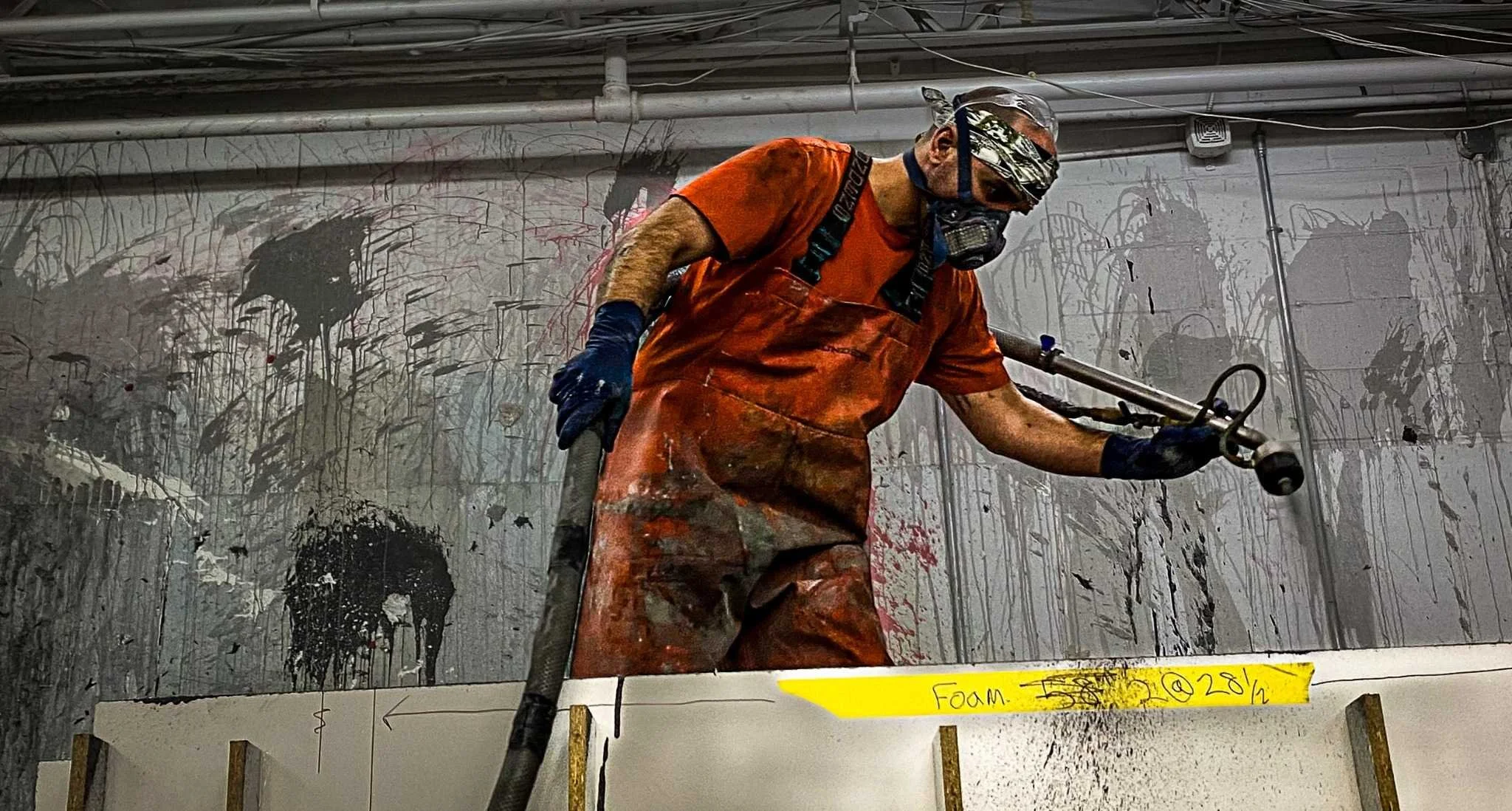 Spraying GFRC during fabrication of the monumental LOVE concrete sculpture at The Concrete Anomaly studio.