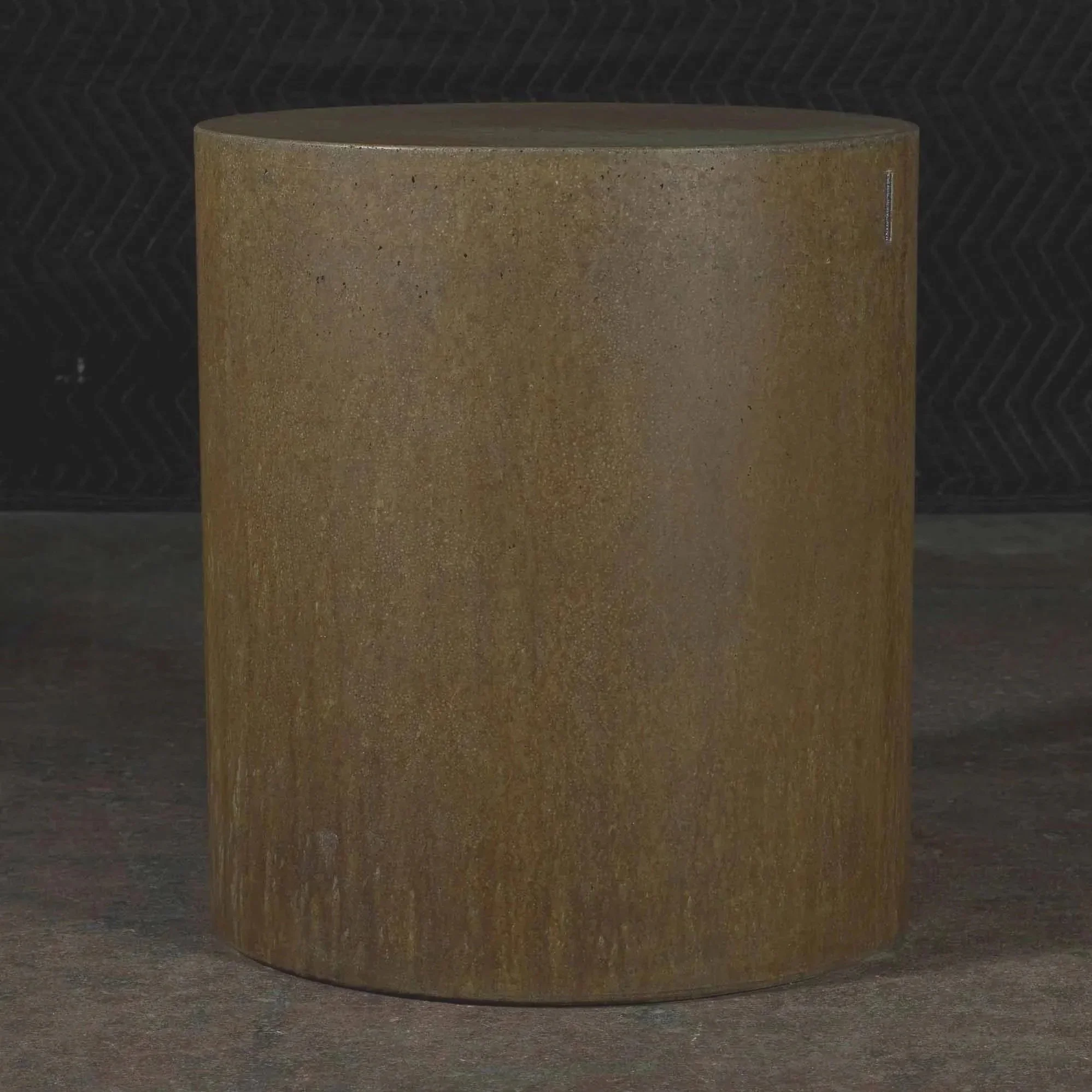 Concrete side table from line ZERO series with oxidized steel-inspired rust finish and layered mineral surface by Dylan Myers.