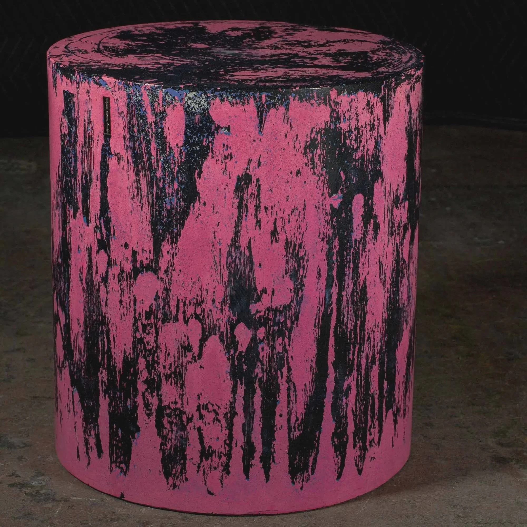 Hand-cast GFRC concrete cylinder featuring layered black erosion markings, saturated pink pigment, and raw expressive surface texture from The Concrete Anomaly.